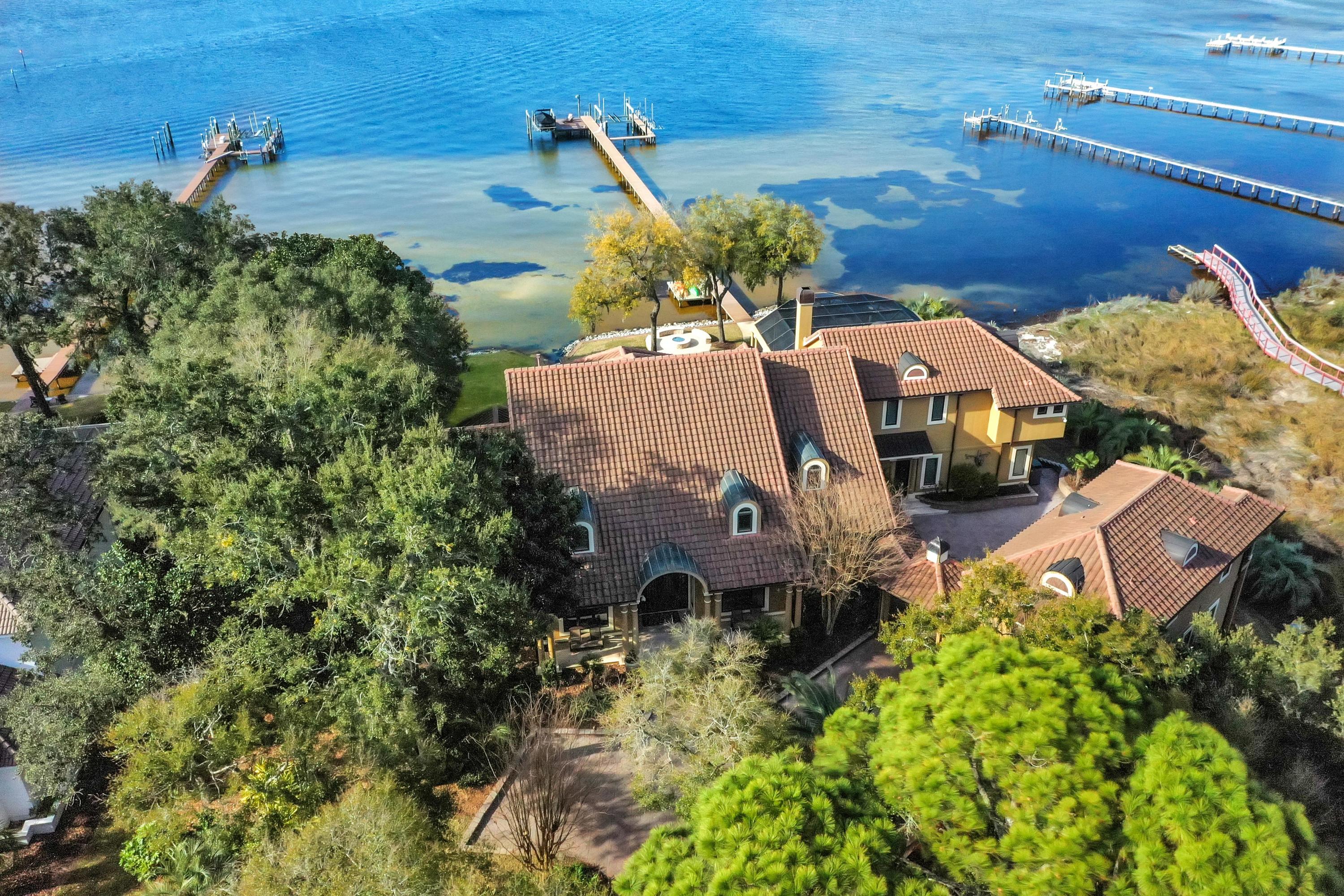 TURN-KEY, FULLY FURNISHED OPPORTUNITY, INCLUDING MOST ALL ACCESSORIES AND AUDIO/VIDEO! *LOMA & DEEP-WATER ESTATE* 4502 Olde Plantation Place is a most impressive waterfront family compound situated on one of the largest lots in Kelly Plantation, which is an exclusive, gated enclave, offering a host of amenities, and conveniently located to commercial conveniences of Destin, Florida.  Oriented on a private cul-de-sac, the estate's fabulous dock extends to deep-water on the Choctawhatchee Bay, which formerly moored a 75' yacht.  The dock contains a paddleboard launch, (3) jet ski lifts, (2) high-capacity boat lifts, all Treks planks, security cameras, speakers, and gorgeous lighting.  The renovated interior and exterior finishes throughout exhibit perfection, the results of which will...  offer your family instantaneous, turnkey use and enjoyment!  This smart home offers some of the latest technology in audio & video, lighting, and state of the art security.  Two substantial renovations have occurred within the last 8-years, not the least of which includes a new roof and new HVAC units.  The summer kitchen is phenomenal, and adjacent to the newly finished, heated pool and hot tub, all of which is under a screened enclosure, and provides convenient access to a powder room.  The adjacent guests' quarters feature an en suite bath.  The compound features a beautiful carriage home above an over-sized three car garage and fitness studio.  The carriage home contains a large living room and full kitchen with Wolf and Sub-Zero appliances, and spacious bedroom, en suite bath, and closet.  A powerful natural gas-powered generator will operate the entire compound should the need arise.  The owner has moored a 75' motor-yacht and 43' Everglades, while enjoying year-round navigability from the exceptional dock configuration, with the average depths of water under the slips being +/-6' during the winter months, and +/-10' in the summer.  The home is owner-occupied, thus advanced notice to accommodate showings is required.  Please inquire for further details, and to schedule a private showing.