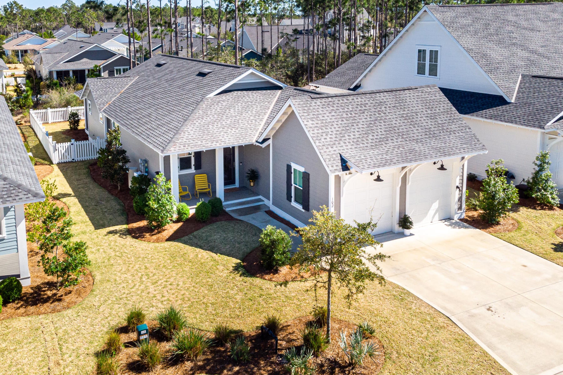 Lovely home in WaterSound Origins, located in the Pathways section offers 3 bedrooms, 3 baths, a 2 car garage, generous porches and a fully fenced in backyard. This open concept, one story plan features beautiful light hardwood floors throughout, a pretty kitchen with stainless appliances, a large island, quartz countertops, a pantry and bar area with beverage center. The spacious master has an elegant ensuite bath and a large walk-in closet. Additional upgrades include designer light fixtures, quartz countertops throughout and v-groove wood walls in the entry foyer. The Watersound Origins community is an amenity rich neighborhood including unlimited golf, pool & fitness center, miles of nature trails, tennis courts, unlimited golf, use of kayaks and canoes & a floating dock providing... exploring, paddle boarding, fishing and so much more.