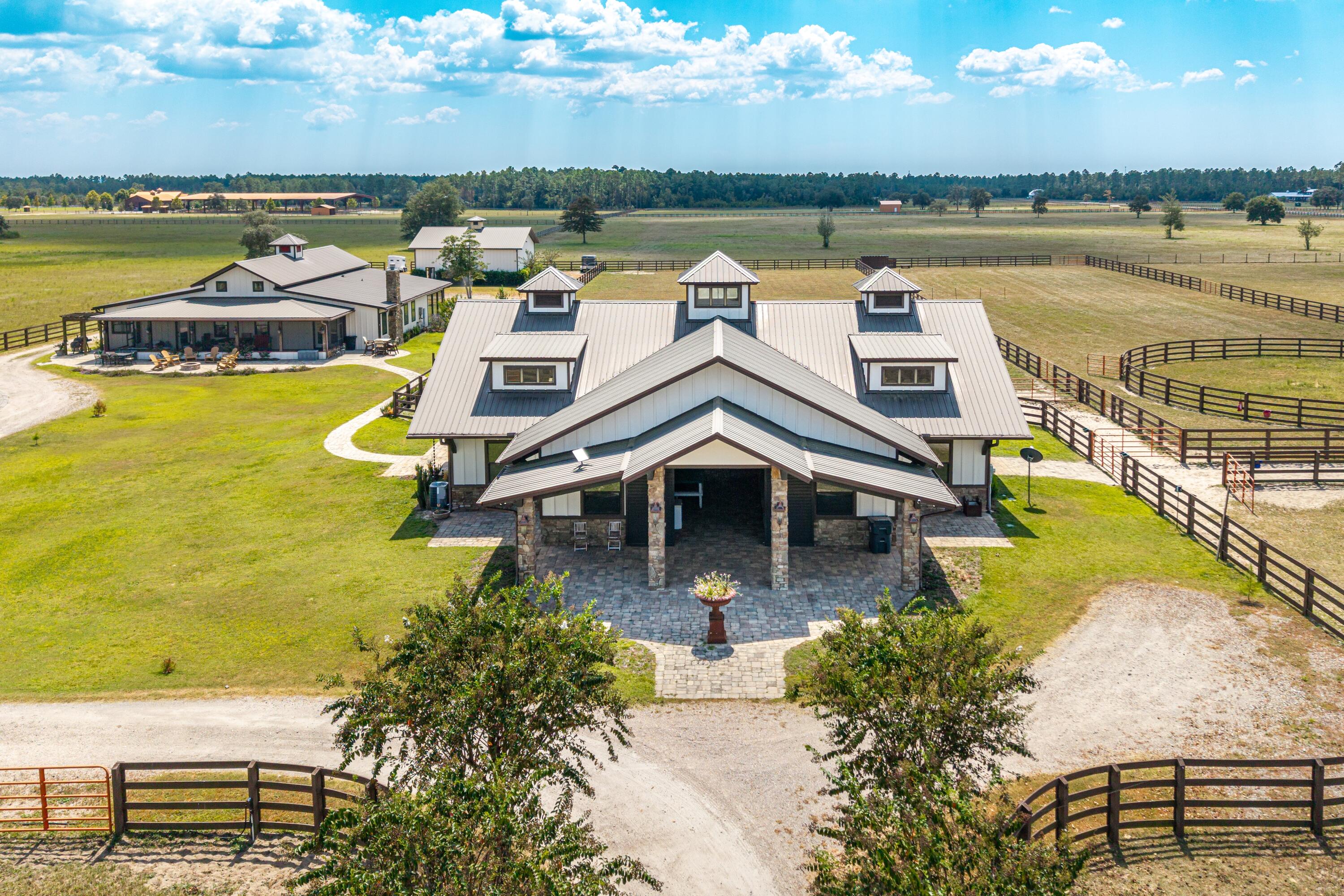 10.51 acres of Luxury Equestrian Living! Experience the perfect blend of modern luxury and country living at this fully renovated and expanded horse farm estate. With premium stable facilities, this property offers both refined living spaces and first-class equestrian amenities including 6 horse stalls.

Inside the main house, you will find 4,500 sqft of a fully renovated home in 2024 including 5 bedrooms, 5.5 baths, new wood flooring, high accent ceilings, and an open concept great room at the entrance. The gourmet kitchen features custom wooden cabinetry, granite countertops, and stainless steel appliances, making it both stylish and highly functional. Two spacious living rooms and a second kitchen provide for plenty of room for entertaining. This home comes fully furnished for a move-in-ready experience. 

Beyond the home, the estate offers upgraded stables, fenced and well-manicured pastures, and a rear storage shed for added convenience. The stable facilities remain in excellent condition and are well suited for horse care, training, and boarding. This turn-key deluxe equestrian setup is a horse lover's dream with each of the six stalls including double-rotating fans, automatic watering bowls, anti-fly misting system, and a covered paddock. There is a beautiful guest quarters attached to the stables including a third kitchen, full bathroom, and bedroom. There is also a separate wash area and tack area. 

Whether you are an avid equestrian or want a slice of luxury countryside close to the beach, this property is for you! Please call/text Taylor Simpson 850.333.2282 and/or Brooke O'Keefe 850.499.2031 to set up a showing today!