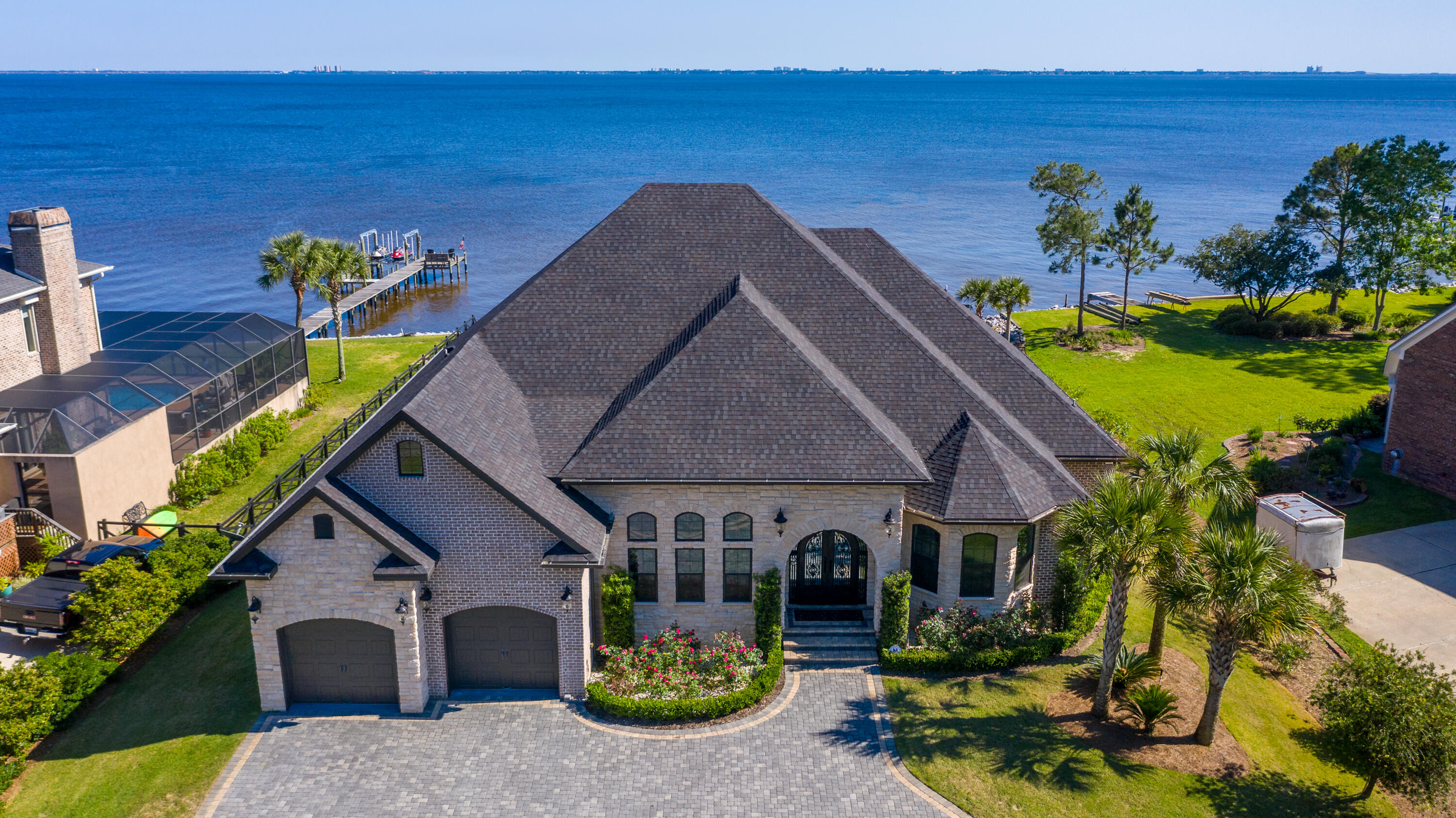 ASTONISHING WATERFRONT HOME-- One of a kind, meticulously custom designed & built home on the shores of Choctawhatchee Bay in Niceville with unobstructed views all the way to Destin & Crab Island.  Very spacious open floor plan, perfectly built to extend entertaining on the 45 ft covered outdoor living spaces with an outdoor kitchen, dining, and seating area accented with the gas fireplace, all overlooking the enclosed pool and the expansive Bay.   Dolphins run right off your dock every  morning and evening!  Just sit down, relax, sip your coffee, and watch out for them. 
Enjoy watching and listening to the wide variety of birds that are so much a part of the neighborhood. -- see how some of these aquatic birds dive into the bay at feeding time. ADDITIONAL FEATURES OF THIS HOUSE INCLUDE:  
Completely adapted CONTROL-4  hard-wired SMARTHOME SYSTEM, RUSSOUND surround sound and audio system throughout the home, NEST ecological thermostat; "Super Screen" pool enclosure (10 yr guaranteed) with added UV protection and custom engineered steel frame to maximize waterfront views from any corner of the house; salt water heated pool and spa, with self filter & OmniLogic SMART system; open-cell foam insulation for maximum energy efficiency ; Timberland solid core doors; PGT impact resistant hurricane windows & doors; Restoration Hardware (RH) decor lighting, fixtures and accessories; 120 ft estate-like driveway (pavers); custom designed double door entry (10 x 8); custom coffered ceiling designs, German engineered (Synoris) garage door lift systems, and many more features.  Contact your agent for additional details and features on this home.