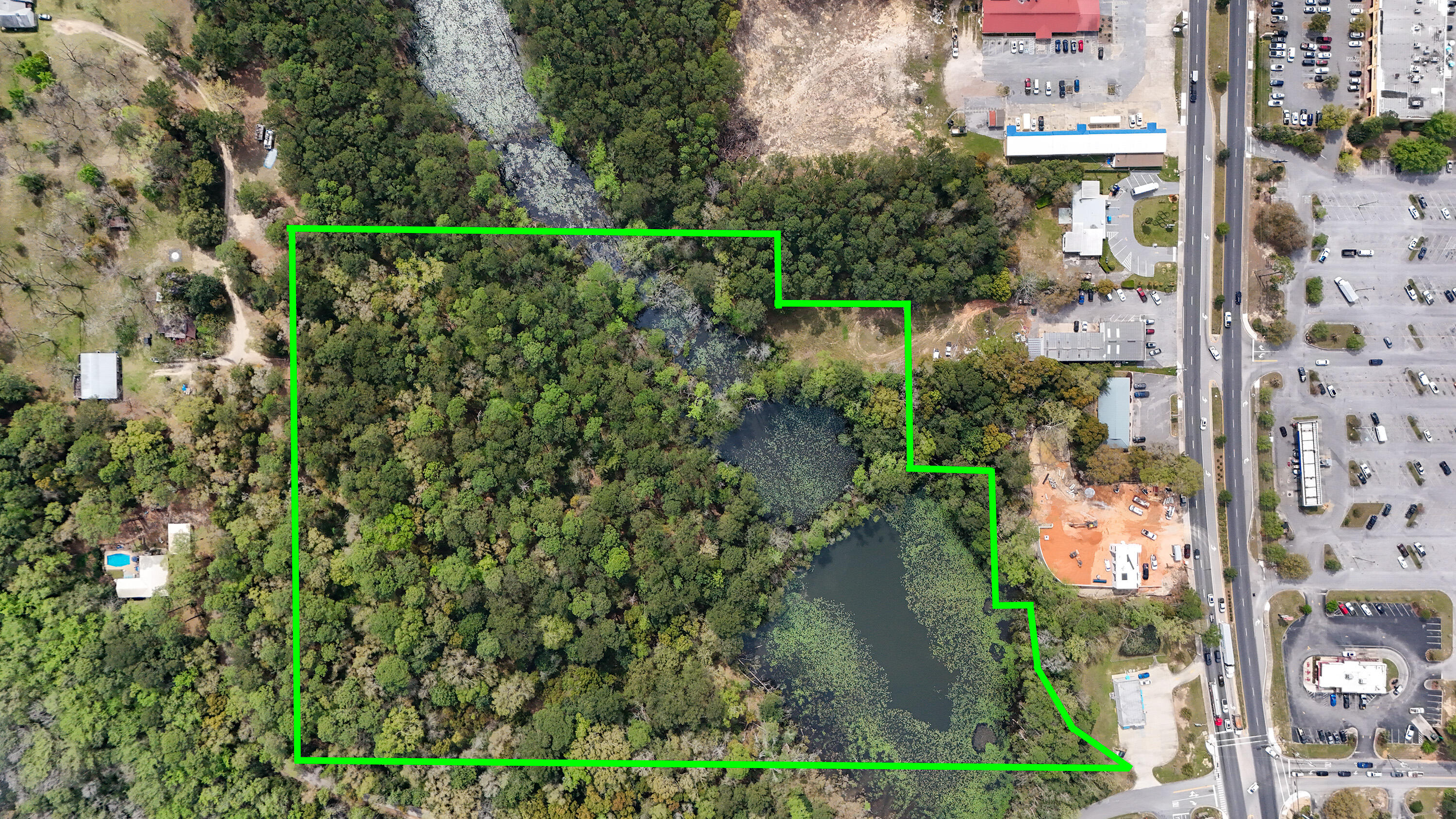 This exceptional 15 ACRE COMMERCIAL property, ZONED C2, is strategically located just off US HWY 331S, across from WALMART and less than 1 MILE NORTH OF I-10, in the rapidly growing area of DEFUNIAK SPRINGS, FL. With convenient traffic light access from Corbett Drive and clear visibility from 331, this property offers unparalleled potential for a variety of commercial ventures.
Offering 15 ac +/- altogether, with approximately 10 ACRES UPLANDS (mostly level), plus additional natural features including a beaver pond and creek. C2 ZONING allows for diverse uses such as hotels/motels, apartments, retail stores, professional offices, banks, restaurants, auto dealerships and more. Easily seen from Hwy 331, the sellers have added an additional opportunity for a 331S MONUMENT SIGN. Flexible options include subdividing the property into 2, 3, or more parcels to suit your specific needs. Sellers are creative and willing to consider various, serious proposals. Whether you're looking to develop a single-use project or a mixed-use complex, this property can accommodate your vision. A completed HOTEL/MOTEL FEASIBILITY STUDY is available for review for serious buyers. With access to electric, city water and city sewer, this property is poised to be a project with the pieces of the puzzle needed for a straightforward start.

The natural features and layout of the property also provide numerous opportunities for landscaping and design. This is a rare opportunity to secure a prime piece of commercial real estate in a thriving market.