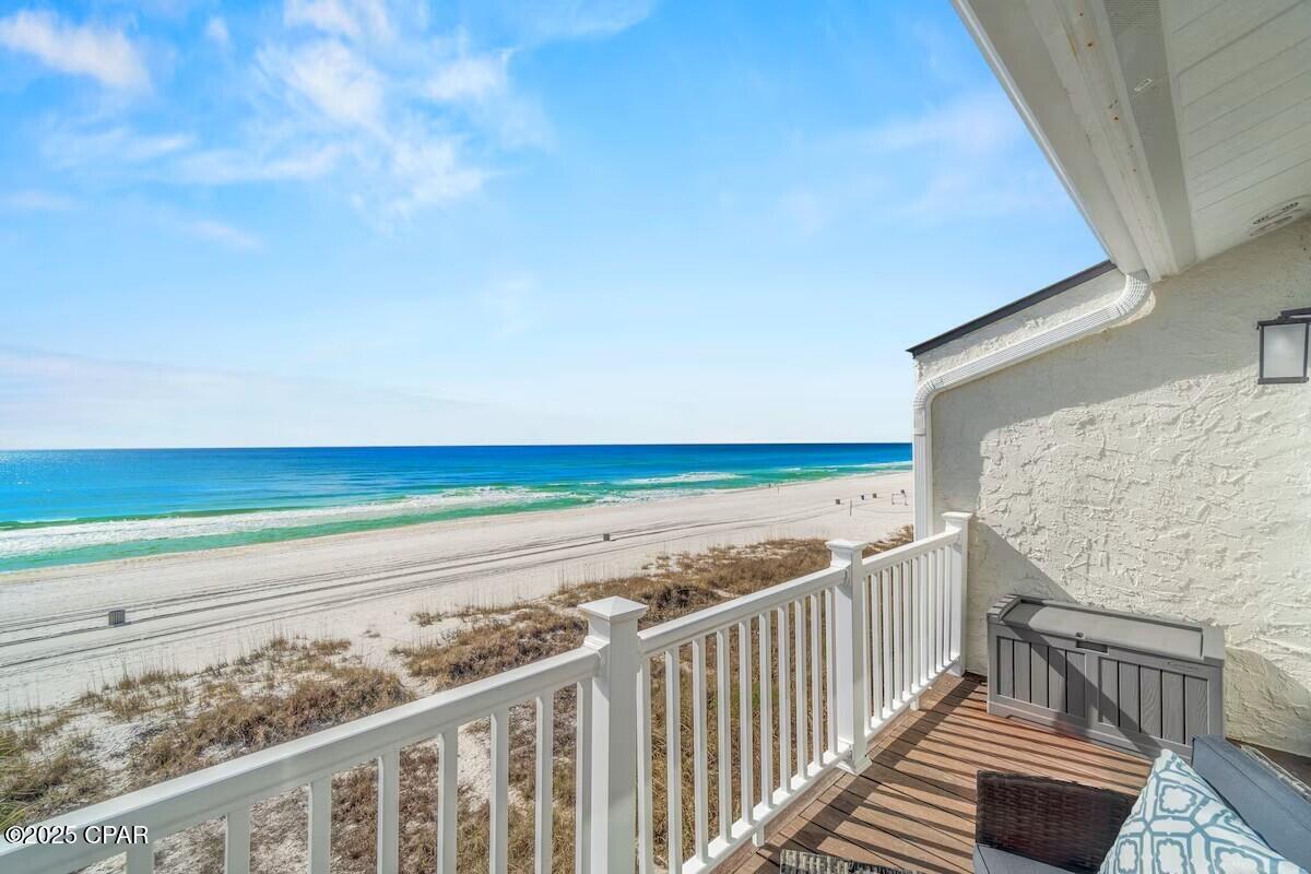 MAJOR PRICE REDUCTION!!! ----- GULF-FRONT, NO HOA, RENTAL READY WITH $139,559 ON THE BOOKS! Step directly onto the sugar-white sand from this remodeled 5-bedroom, 4 full baths beach retreat offering sweeping Gulf views from the main living level and private bedrooms. Designed for gathering, the open living/dining/kitchen frames the emerald water as the backdrop for sunsets, seafood nights, and memory-making. A clever 10' x 12' loft in one bedroom creates an extra sleeping zone or kid-approved hideaway--ideal for maximizing guest capacity. Recent updates and the seller-reported 2,232 sq ft of heated/cooled space include an enclosed former garage that expands everyday comfort and rental flexibility. Multiple bedrooms on separate levels provide privacy for larger groups, while four full baths keep beach days effortless. Outside, rinse off and head straight to the deck to watch dolphins cruise and the sky glow at golden hour. Major perks: NO HOA a rare Gulf-front find that supports short-term rental potential plus a layout and location travelers love: direct beach access, panoramic views, and minutes to coastal dining, shopping, and entertainment like Top Golf. Dolly's Pirate Voyage, Pier Park!.