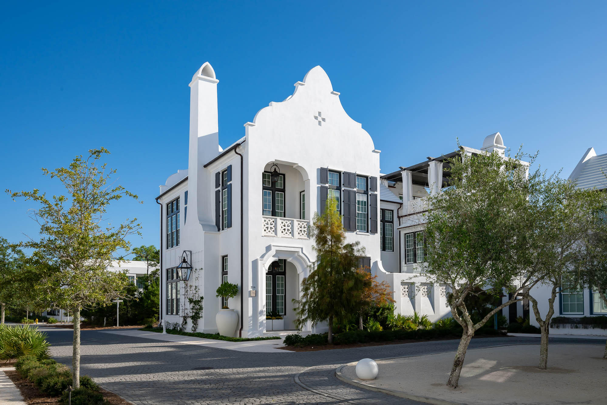 Acquired excellence has been achieved with the exquisite architectural design of 214 N. Charles Street by Domin Bock Architects & Fouquet Interior Design. No detail was spared with design and fixtures & finishes.  This incredible home looks upon one of Alys Beach's most intimate greens, Papilio Park. Sight lines from the generous 3rd level roof terrace provides views of the Alys architecture accented with Gulf of Mexico views.  5,745 square feet of elegance delivering 5 bedrooms, 6 full bathrooms and 2 powder bathrooms.
Meticulously bound in all details, 214 N. Charles Street encapsulates grandeur and functional living for partial or primary residency. Indoor & outdoor living comingle creating compatibility into one space, taking full advantage of the home's numerous outdoor gathering locations.  From the courtyard with pool & grotto spa, both heated independently, private terraces from bedrooms, punctuated by the 3rd level with media/entertainment room opening to the expansive covered roof terrace.  The owner will have elevator access to all 3 levels of the home.  
Entry to the residence captivates one immediately standing beneath 15' trayed ceilings with cascading Venetian Plaster from ceiling to floor. The ceilings provide overwhelming volume and reflections of natural light illuminating the Venetian Plaster which cascades on the 32" x 32" Glassos tile flooring.  Ralph Lauren chandeliers create elegance in the evening. The picturesque setting of the courtyard is viewable from most all rooms.
The home's first floor astonishes the most design savvy accentuated with custom millwork boasting interconnected living & dining rooms and gourmet kitchen anchored with a La Cornue professional range flanked on each side with individual Sub-Zero freezer & refrigerator. An intentional Mosaic tile backsplash frames the setting of the large marble slab island as the kitchen's focal point.  Preparations are found in the Butler's pantry outfitted with dual wine refrigerators, microwave, & flush mounted coffee & espresso maker.  Exquisite and extensive custom cabinetry & hardware provides stately use for the chef in mind. 
Entertaining après dinner transitions to the courtyard loggia outfitted with gas fireplace, wet bar, a visually pleasing fountain, having a private outdoor full bathroom.  Captivating views abound as guests look to the courtyard pool and spa grotto.  
Transitioning to the second floor takes one to another design element not yet seen.  Oak stair treads cast with Mother of Pearl risers connect floor to floor with large EF San Juan windows adding to the anticipation of what is to come at the 2nd level.  Immediately greeted by a parlor yielding a secondary media room and wet bar, framed by floor to ceiling windows looking upon the courtyard below and views of Papilio Park add yet another gathering space.
Each of the home's 5 bedrooms, with en suite bathrooms, greet one with their own individual design character casting peaceful refuge for owner and guests.  The primary suite is like none other.  Sights are set on courtyard views below in conjunction with Papilio Park from interior space or the private balcony.  The beautifully atoned fireplace is the anchor point for this luxurious primary.  Marble abounds in the primary bathroom hosting a soaking tub below a designer light fixture with separate shower.  The primary closet is something to behold.  Mirrored custom cabinetry set within custom millwork, vanity station, hidden safe room, and one of three laundries found in the home accentuate this home's amenities.  
A separate, detached guest suite accessible from the home or via exterior private stair access is perfect for longer term guests.  This suite is designed for comfort & serenity having its own personal kitchen, living room, and laundry enthroned with tall ceilings complimented by custom window treatments.  
Capping the amenities of 214 N. Charles Street, the 3rd level of the home further emphasizes its livability showcasing a media/entertainment room with wet bar opening to the very generous roof terrace suspended above the Town with summer kitchen.  The roof terrace has a covered roof allowing for anytime usage.  Views of the Gulf of Mexico and the architectural roofscapes of the Town are stunning from this location.  
In addition, the home has parking for 5 vehicles & additional guest parking.  This property is a must see.
