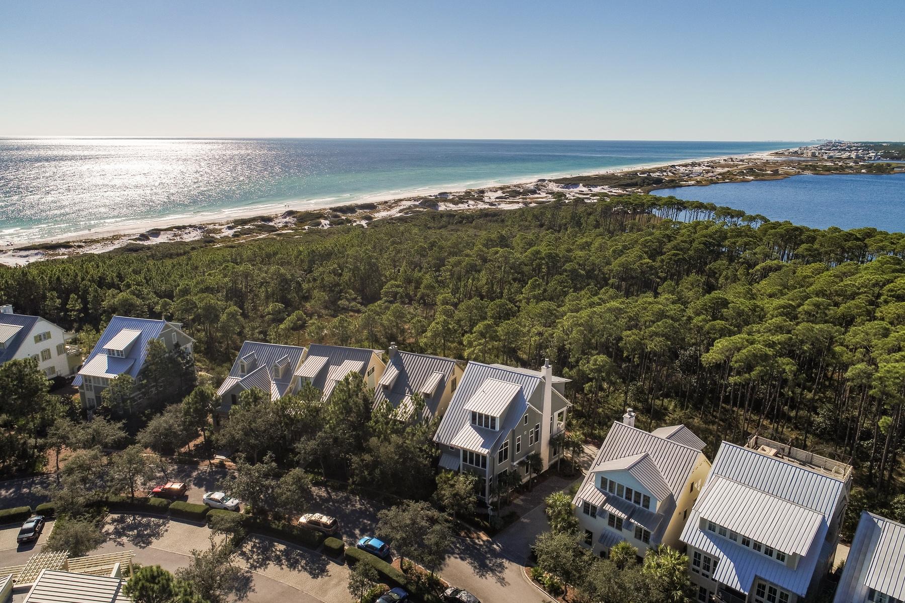 One of a kind rare opportunity to own a beach masterpiece south of 30-A in WaterColor Resort. This beach estate is custom furnished by award-winning Lovelace Interiors in a Rustic Modern style with a coastal flair featuring clean lines and finishes of grays, creams and ice blues that play with and reflect light. Uniquely positioned on a corner lot with unobstructed views overlooking Western Lake and the Gulf of Mexico, this property adjoins Grayton Beach State Park's rare Coastal Dune Lakes and its 356 acres of pine forests. With three levels of luxury living, this stunning residence radiates elegance and sophistication. Custom built by James A Rice and designed by Thurber Architects, this home is as unique as its surroundings. It offers 5 bedrooms, including a double-bunk room, 4 Full baths + 2 Half Baths and is constructed with only the finest materials. Custom reclaimed Pecky sinker cypress was selected for: kitchen cabinets & hood, interior doors, curved entry walls, and beamed ceilings. Features include an elevator, chef's gourmet kitchen equipped with Thermador appliances, 56 bottle wine cooler, Shiplap plank walls, 5'' white oak plank floors with custom finish and color, 8''x12'' and 6''x12'', cedar plank exterior, imported tile, Carrara marble countertops throughout the bathrooms and kitchen, 3 wet bars, ice machine, 2 gas fireplaces, security system, Sonos iPad/iPhone controlled audio system, 2 car garage with 14'ceilings in case one might need a car elevated, impact hurricane Miami Dade windows, irrigation system and lighted landscaping. The first floor will impress immediately with 14' Pecky cypress ceilings and reclaimed Pecky sinker cypress walls which adorn the entry way leading to the stairway and elevator. This floor hosts one master suite, a second bedroom and a bunk room equipped with four bunks, each hosting its own private TV, an oversized laundry room with a front loading washer and dryer and a separate 'mud room' shower off the 2 car garage. Ascend the stairway to the second floor grand living area which offers a seamlessly flowing floor plan connecting indoor and outdoor living spaces. This area has a wet bar, ice maker and a chef's gourmet kitchen, a true entertainer's delight. Your eye can't help but catch the distinctive tabby scallop shell stucco gas fireplace and cypress mantle. The expansive covered lanai overlooks unobstructed views of the dune lake and gulf. The chef's gourmet kitchen features cypress kitchen cabinets. The dining area adjoins the kitchen offering a buffet serving wet bar. The third floor offers two master suites. The first master has a gas fireplace, oversized walk-in closet, private covered lanai with an outdoor shower offering the ultimate privacy, a tranquil luxurious master bath which overlooks unobstructed views of the dune lake and gulf. The third floor offers a 2nd master suite with custom designed walk-in closet. The third floor has a generous wet bar area to help you enjoy morning coffee or an evening cocktail. This estate offers a modern, sophisticated flair through the use of light fabrics, modern furnishings, reflective finishes and well-placed unique accent lighting that is complemented by the occasional organic or sculptural wood piece, the sparkle of glass, and chrome and silver leaf accent pieces. Shimmering, plush area rugs provide a light, inviting anchor for each furniture arrangement, and also provides a dramatic contrast from the pine floors. With impeccable design and exquisite finishes no expense was spared to create this one of a kind residence. The builder created this home to satisfy the most discriminating buyer!