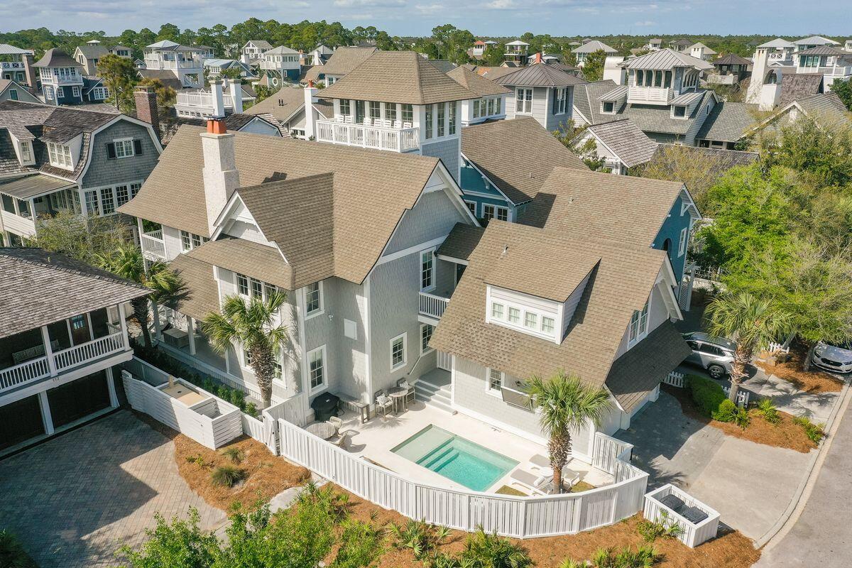 Once in a great while, an ideal location and fabulous space combine to create a truly exceptional property. Positioned one home away from the Gulf in Watersound Beach along a picturesque boardwalk, this home has been meticulously redesigned from top to bottom including the addition of a private pool, new furnishings, and updated finishes throughout. Offering main floor living, the open kitchen, dining and living area are light and bright with shiplap walls, quartz counters, wet bar, and a fabulous fireplace. The main floor has a large owner's suite with its own porch, and resort style bath with large shower, polished nickel faucets, and beautiful freestanding tub. On the 2nd level is a second owner's suite with private balcony for enjoying coffee while overlooking the boardwalk below. This owner's suite also has built-in twin platform beds, making it an ideal family suite for a larger family. In addition, the 2nd level hosts bedrooms 3 and 4, each with king beds and ensuite baths. From the 2nd level, you may access the stylish carriage house, which provides the home's 5th bedroom. The carriage house offers a private living space with a king bed, built-in bunk beds, along with a desk area and beautifully decorated bath. With exceptional gulf views, the tower is a spectacular place to watch sunset in the comfort of air conditioned seating or outside enjoying the breeze. The tower's wet bar makes it simple to serve guests while taking in the enviable gulf views. The recent renovation includes newly refinished heart of pine flooring , custom tile, designer furnishings and fabulous lighting. A brand new heated private pool completes the resort-living style of the home including an outdoor television and grilling area. WaterSound Beach is a premier 30A beach community with gated access situated on 256 acres of natural sand dunes with over a mile of white sandy beach, dunes, community parks, pools and boardwalks.