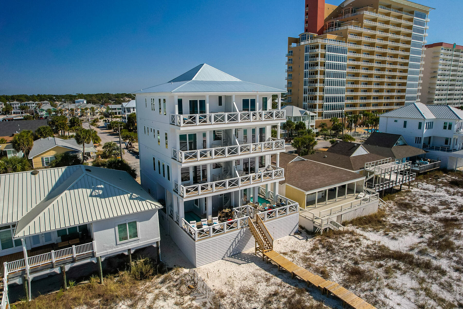 Welcome to this truly stunning luxury beachfront home located on the sugary white sands of the Gulf of Mexico in Panama City Beach. This newer constructed 5 bedroom, 5.5 bath duplex comes fully furnished and can sleep up to 19 guests making it an excellent investment property. 
The private heated pool with direct beach access is a fantastic addition, providing convenience and relaxation for you and your guests. The open floor plan on the second floor, with its gourmet kitchen and spacious living and dining areas, creates a perfect space for entertaining. The panoramic views of the Gulf of Mexico from the balcony off the living room are breathtaking. 
The third and fourth floors continue to impress with their well-appointed guest bedrooms and ensuite bathrooms. The custom cabinetry, quartz countertops, and designer tile with frameless shower doors add a touch of elegance to these spaces. The fourth-floor guest bedroom, with its custom-built queen over king bunk beds, offers a unique and comfortable sleeping arrangement. 
The oversized primary bedroom on the fourth floor is a true highlight. With its private balcony and unobstructed views of the beach, it provides a serene retreat. The master bath is equally impressive, featuring a walk-in shower, freestanding soaking tub, quartz countertop with dual vanity, and custom cabinets. 
Additional features like hurricane impact windows and doors, upgraded lighting fixtures, tankless hot water heaters, and multiple decks enhance the overall appeal and functionality of this gorgeous home. 
Overall, this property offers a luxurious coastal living experience with its stunning design, high-end finishes, and convenient amenities. It would surely be a dream home for anyone looking to enjoy beachfront living.