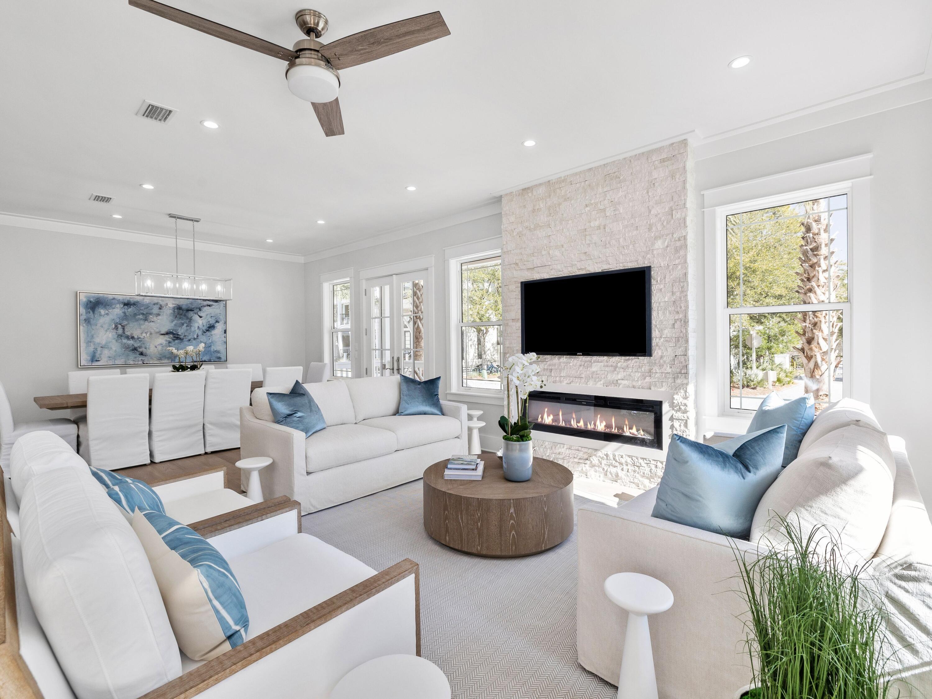 Nestled in the highly sought-after community of Seacrest Beach along the picturesque Hwy 30A, this exquisite newly constructed beach house is a true gem, being offered fully furnished for your immediate enjoyment. Boasting 5 spacious bedrooms and 5 and a half luxurious baths, this home is a blend of comfort and elegance, featuring stunning wood flooring that flows seamlessly throughout. The layout includes two primary suites—one conveniently located on the first floor and another on the third floor—providing privacy and comfort for all guests. With three inviting living areas, the main gathering space on the first floor is perfect for relaxation, complemented by a charming fire feature that adds warmth and ambiance. Ascend to the second floor to find a second living area, along with a sprawling covered outdoor living space, ideal for entertaining or simply soaking in the coastal breezes. The heart of the home, the open kitchen, captivates with its modern shaker-style cabinets, gleaming tile backsplash, and top-of-the-line appliances, sure to please any culinary enthusiast. Just outside the kitchen, you'll discover a beautifully designed wet bar, complete with open wood shelving, a wine refrigerator, and an ice machineperfect for hosting gatherings. Enjoy the fresh air and tranquil views from the porches attached to three of the five bedrooms, and relax on the two expansive porches off the first-floor living and kitchen area. Conveniently located, the Seacrest Beach shuttle picks you up right outside your door, whisking you off to the mesmerizing beach. Start your day with a delightful breakfast at a charming café in the neighborhood, or explore the delightful options for dining, boutique shopping, and entertainment just a few blocks away in Rosemary and Alys Beach. Revel in leisurely strolls along the stunning white-sand beach or try your luck at fishing. Golfers will appreciate being just minutes away from the well-regarded Camp Creek Golf Club. For those who love nature, Camp Helen State Park lies to the north, offering a stunning natural environment rich in outdoor activities such as birding, hiking, kayaking, and fishing on the serene Lake Powell.