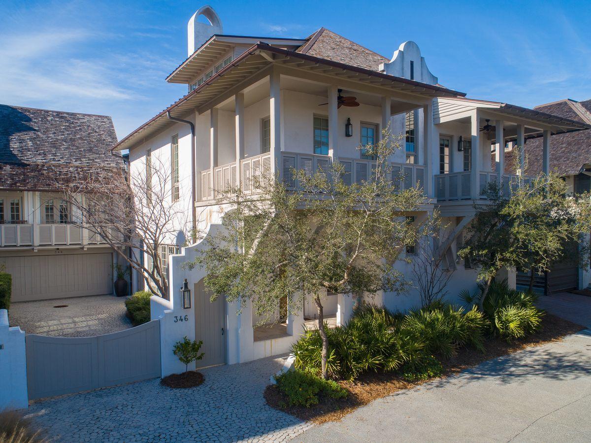 Forwardly designed and masterfully constructed, this quintessential home is nestled within one of the most iconic corners of Rosemary Beach. An elegant architectural wonder positioned steps away from the sugar white sand of the coast and the sea blue green of the Gulf of Mexico, 346 W Water Street enjoys its flow from interior living to the spacious courtyard.
The home inspires through masterfully crafted details including Venetian plaster walls, pecky cypress columns and beams, masterful Groin Vault ceilings and oversized windows. The interior and exterior fireplaces provide exceptional gathering spaces to contemplate the day ahead or unwind from a day at the beach. As one enters through the arched hand-carved teak front door, the crisply designed living space welcomes! And moves eloquently into the transitional dining space. Beyond the dining area is the progressively designed kitchen, equipped with a custom Viking range and Quartzite kitchen counters. The main level of the home also features a spacious laundry room and butler's pantry, and a full bath leading to the pool and courtyard.

Walking up the sun drenched stairway with burnished brass balusters, the second floor welcomes with a naturally lit living space, Gulf view balcony, and four of the five bedrooms. An elevator is available to transport between the first and second floors. The third story of this elegant home provides the fifth private bedroom suite, a media room, and a second laundry area.

Adding to the convenience and accommodation of this stately home, across the charming courtyard resides a freshly renovated carriage home equipped with a full kitchen, charming living space, sleeping loft and tastefully updated decor.

The heart of this beach retreat can be found in the oversized courtyard, featuring a full Dacor summer kitchen and plunge pool with water feature. Build a lifetime of memories by the outdoor fireplace, and enjoy the unique beach lifestyle of this extraordinary Rosemary Beach home.