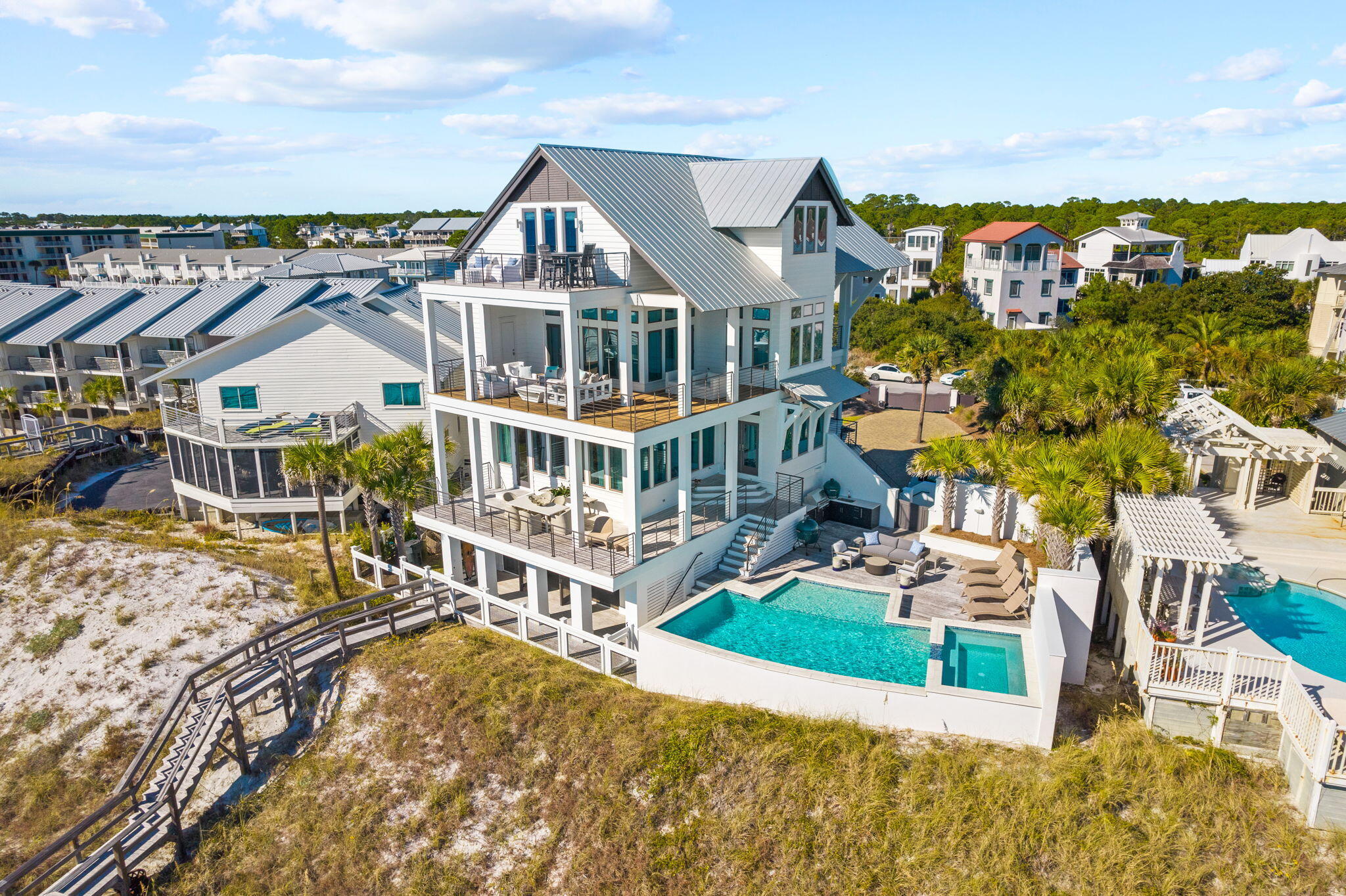 This extraordinary coastal estate, situated on over an acre, boasts 95 feet of Gulf frontage. Renowned Nashville designer Chad James has embodied this residence with an aura of southern opulence and sophistication, while architect Geoff Chick and builder Chris Clark have reimagined this private coastal retreat.

Step inside this luxurious estate and experience a seamless fusion of timeless design and unrivaled comfort. The entrance, accessed through a private gate, sets the stage for a truly remarkable experience that also offers endless potential for further development. As you explore the grounds, you'll discover a custom Gulf front pool surrounded by lush thoughtfully designed landscaping, creating a serene oasis. The southern-style porches call you to unwind and savor the breathtaking views of the Gulf's mesmerizing emerald green waters and pristine sugar white beaches.

Every detail has been thoughtfully curated to create an atmosphere of refined coastal elegance. The interior features exquisite reclaimed heart pine floors, elevated ceilings adorned with old Pennsylvania Dutch barn beams, and an open kitchen and living room that capture the inspiring eastern and western gulf views. The kitchen is a culinary masterpiece, boasting top-of-the-line Viking appliances, custom cabinetry, and a wet bar complete with a "Sonic" ice maker. The main living room seamlessly transitions to a large wraparound balcony, perfect for al fresco dining with a view.

The second and third floors have impeccably appointed guest suites, each one a sanctuary in its own right. The master retreat is a haven of unparalleled luxury, complete with a private balcony overlooking the gulf and a master bathroom with exquisite marble finishes. A fourth-floor addition offers additional living space, a charming bunk room, and a separate living room or theater that provides unobstructed views of the gulf. Additionally, the home offers direct elevator access from the 1st floor to the 3rd floor, also offering an oversized two car garage with enormous room for storage throughout.  The 1st floor outdoor living area is elevated to an art form in this exceptional estate - a screened-in space seamlessly connects to the private beach, creating the perfect setting for entertaining or enjoying leisurely afternoons. The meticulous landscaping and stunning architectural finishes further enhance the allure of this property, creating a true unique coastal paradise, ensuring a lifestyle of ease and comfort. Located in close proximity to premier communities and amenities along 30A, this coastal retreat is truly a haven for those seeking a luxurious quiet beachside lifestyle.

While this remarkable residence has never been rented, it presents an excellent opportunity for short-term rental income. Projected potential earnings of over $700,000 further solidifies its appeal as an exceptional investment opportunity. Buyer to verify all surveys and dimensions.