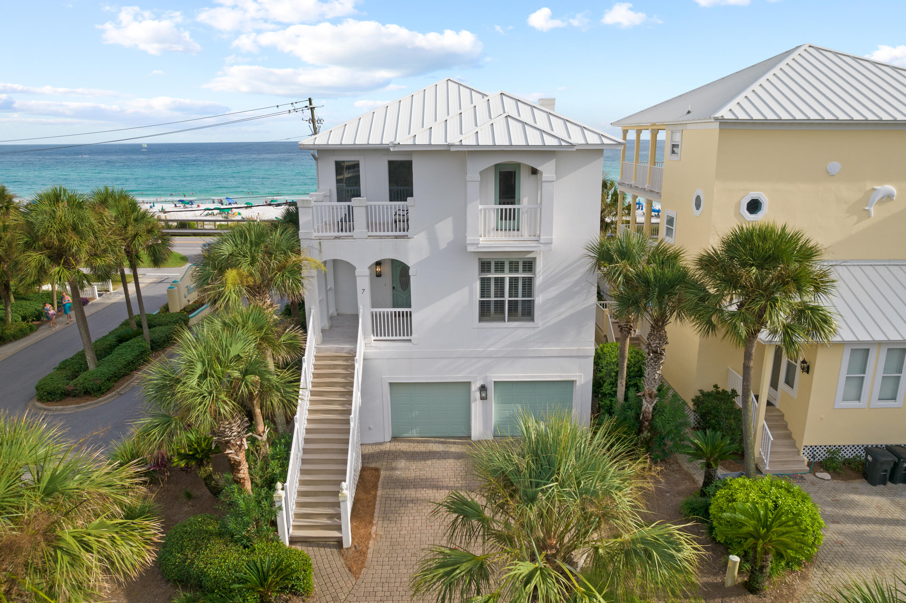 7 Saint Martin is a stunning, updated beach home with spectacular, unobstructed views of the prestigious white sandy beaches & emerald-blue waters that are the hallmarks of the Emerald Coast. Nestled in a prime position directly across the street from the beach in Maravilla Shores private gated community, with easy access in and out of the area, this home features over 3500 square feet generously spread over 3 stories with multiple balconies, attached two car garage, parking for four and room for sleeping up to 19 guests.  The first floor is a beautiful space with a full kitchen, bath with large shower, built-in queen over queen bunks, and private king bedroom. Patio seating affords luxurious access for multiple families and/or friend groups to sit and enjoy Gulf breezes. The main entrance to this grand home is located on the second floor with crisp white shiplap and cool ocean blue hues. The open concept, main living area showcases unparalleled Gulf views with seamless flow through the kitchen, dining, and entertainment areas. A counter-top bar and patio with gas grill provide elevated touches for this space. The top level encompasses four of the home's six bedrooms. Here, find the main suite graced with stunning balcony views, king bed, and private spa-like bath with dual vanities, gorgeous soaker tub, and large rainfall shower. Visitors will find an additional king bedroom with private ensuite, and two additional bedrooms sharing a Jack-and-Jill bathroom. 

Wise buyers will appreciate newly upgraded electrical, lighting, and flooring. New and fresh furniture, appliances, and patio furnishings adorn all floors, and a wine fridge and coffee spot have been added to the third floor. Curated décor and furnishings create a preeminent, welcoming space for visitors. With gated, private beach access just 400 feet away, this home is situated for owners and visitors to relish getaways as close as you can get to the beach without being directly on the gulf.  Guests have access to all the Maravilla Shores amenities - 2 pools, tennis, pickleball, basketball, beach volleyball, fitness center, community grilling area and extra parking. Miramar is perfectly situated between 30A and Destin. With its juxtaposition of beach relaxation and multitude of family friendly activities, this short-term vacation rental property provides buyers with the opportunity for optimal return on their investment.
