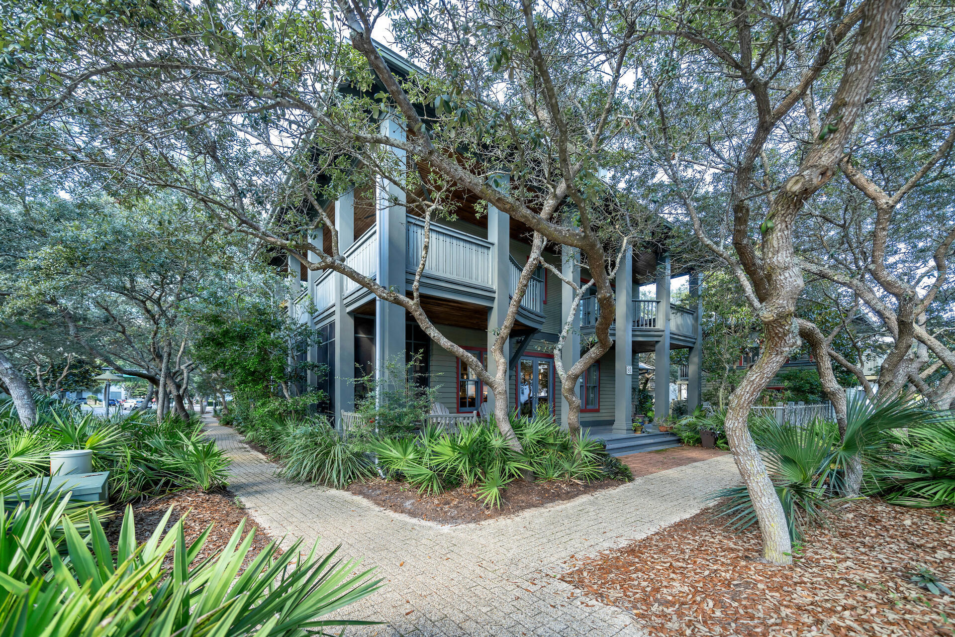 The true history holder & lovingly maintained in Rosemary Beach, the carriage house at 81 Round Road was the first home built (1997) in the community.  The main house followed in 2000.  Outdoor living is the hallmark with a pavered 24' x 22' courtyard, complete with koi pond and lush vegetation.  A gorgeous screened porch off of the first floor living area provides a private haven for enjoying breezes and good conversation.  Open kitchen, living, dining is the focus of the first floor and has been updated with quartz counters and a beautiful marble fireplace.  A first floor bedroom with private bath and laundry make single floor living possible.  The second level contains the true primary bedroom with private bath, a 31' x 6.5' balcony with hot tub.  A second bedroom, (currently used as an office), a sitting room, additional bath and laundry are also on the second floor.  A fun spiral staircase leads to the large 3rd level loft that could be a fantastic bunkroom, though it is currently a studio.  And then, there is the carriage house.  A charming one room studio with murphy bed, kitchen, full bath and laundry - new windows and roof.  So many opportunities to make it your own exist here. The town center shops and restaurants and the beach are just steps from this home. Must see.  Information contained in this listing, such as square footage, is deemed to be correct but should be verified by a buyer.