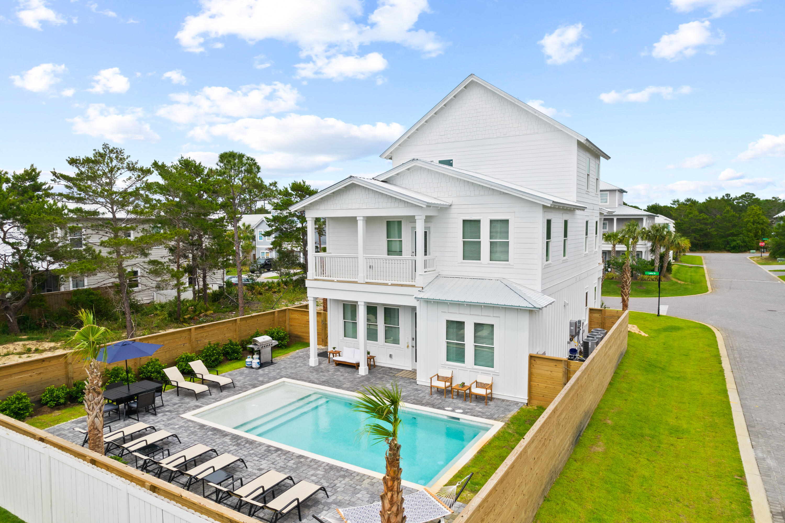Newly completed in 2022, 7 Lake Street is adorned with high end and unique finishes that coalesce to create an ideal vacation rental property. Located in phase II of the gated community of Frangista Beach off of iconic Scenic Highway 98, the Sandy Pearl boasts private, deeded beach access for owners and visitors.  This pristine 3-story home on a private corner lot is finished with modern coastal touches professionally curated and furnished by a local interior designer.  The generous floor plan with stunning upgraded flooring throughout is open, light, and airy – making it both inviting and relaxing.  Seven spacious bedrooms including two on the main level, and a third-floor kitchenette with an 8th king-sized bed allow this home to accommodate up to 24 sleepers in grand style.  The kitchen has commercial grade, stainless steel appliances, upgraded quartz countertops, handmade subway tile backsplash, and custom art pieces to accent the space.  A separate large ice maker and commercial size washer/dryer add ultimate convenience.  Living spaces include brand new furniture, smart TVs, game room equipment, and multi-window coverings. Each of the home's 8 bathrooms is graced with Sellers brand custom tile designs.  Designers brought the same exquisite attention to detail to the outside spaces of the Sandy Pearl, as well.  Landscaping is lush with palm trees lining an oversized parking area/driveway.    Owners can peer down through the overhanging backyard palms from the many suites created by outside decks to admire oversized pavers surrounding the luscious private pool with a kiddie/tanning area attached.  Controlling the settings on the heated pool is effortless with Wi-Fi controlled smart home features.  The space is further defined with rich teak furniture, stainless-steel grill, and hammock for lounging on lazy days.  Take the included 6-passenger golf cart to the Silver Sands Premium Outlet Mall, (home to 110 designer and name brand outlet stores), just 2 miles away. Also within 2 miles of the home are countless restaurants, grocery stores, gas station, CVS Pharmacy, 2 large and popular public beach accesses, and much more!  For golfers, Seascape Golf Course is a 5-minute drive from the Sandy Pearl.
 
On the practical side and beyond the "higher than typical" vacation rental finishes, wise buyers will appreciate the owner's closet with code padlock inside and large storage closet with code padlock outside.  Additionally, builders have included a 10-year pool warranty, upgraded electrical and plumbing fixtures, manufacturers' warranties for all mechanicals and appliances, new, well-supplied sprinkler system, and most impressively, a full builder warranty till May 2023.  Whether you are looking for an investment property or a place to make memories with your extended family, the Sandy Pearl is a treasured find.