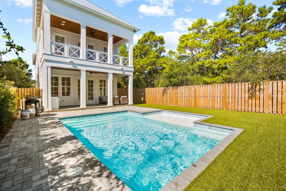Completed in 2021, this pristine beach house south of 30A is available fully furnished and turnkey. It's just the place to enjoy family vacations and memory-making year after year. Designed in a traditional southern style, it boasts full-width porches front and rear and a covered poolside terrace for socializing, entertaining and having fun. A paved driveway and garage provide ample parking and storage for bicycles and beach toys. The interior benefits from lofty ceilings and gleaming hardwood floors complemented by quartz countertops and stainless steel appliances in the impressive gourmet kitchen. It has everything you need to create meals for hungry hordes after a day at the beach. The open family room with its multi-paneled windows and white color palette feels cool and spacious. A refectory table is the perfect place to gather over dinner and discuss the day. Five en suite bedrooms ensure everyone has their own private space, even with16 guests. There's a first-floor guest suite, three bedrooms and a master on the second floor, and a fun 29-ft. bunk room/den for youngsters tucked away in the loft. 

Families will spend many happy hours in the enclosed yard with a private pool for splashing around while dinner sizzles on the barbecue. The beach is just a short walk away for swimming, shelling and sandcastles. Visit the farmer's market and boutiques in Gulf Place or head to your favorite restaurant in Seaside, Florida. Located on the sought-after south side of 30A,  this beautiful beach house is just waiting for you to add your personal touch to make it home.