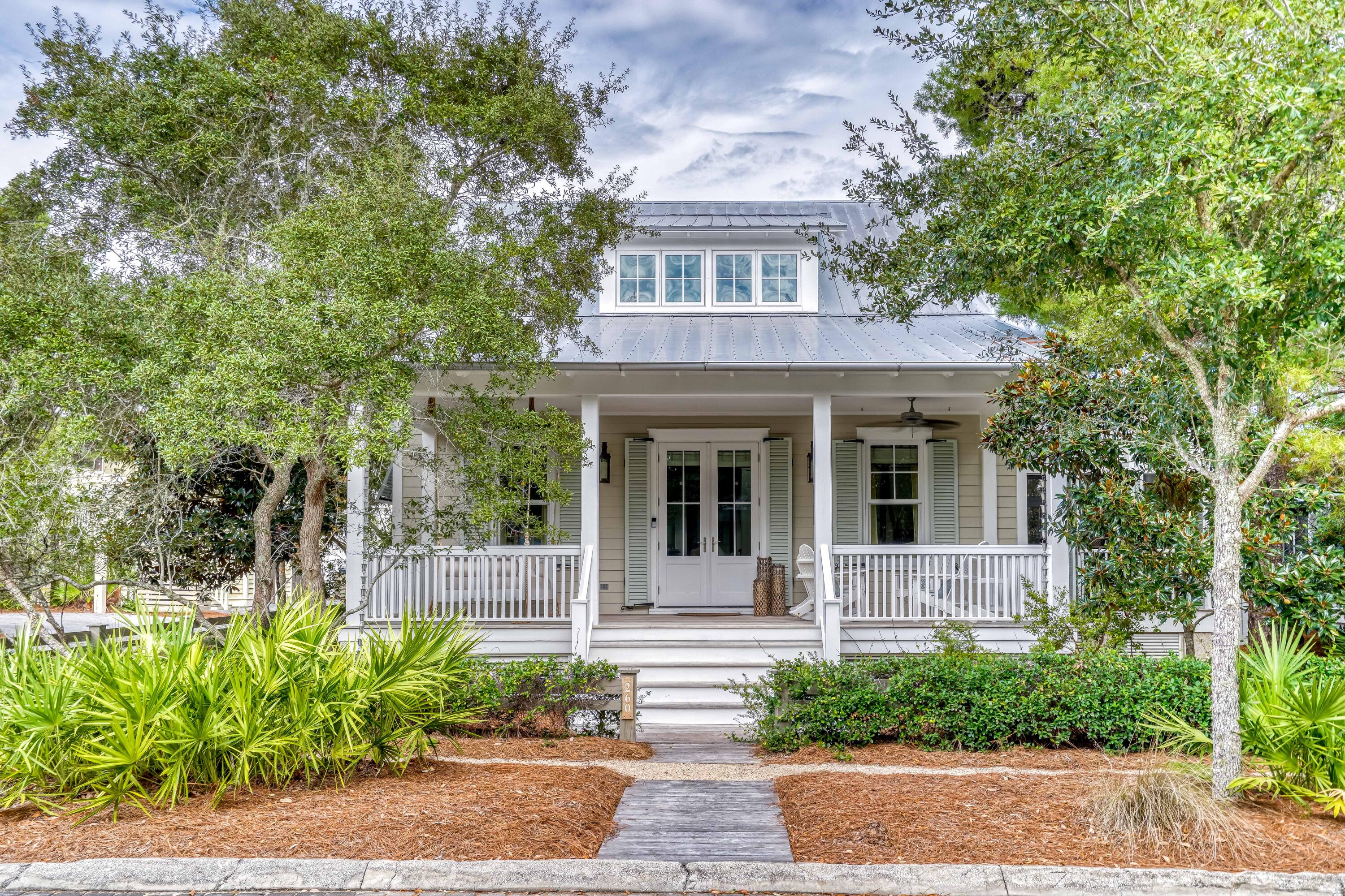 THE ONLY 5 BEDROOM HOME AVAILABLE IN WATERCOLOR! From the moment you walk in the door this TS Adams designed beach house offers the feeling that you have truly arrived at the beach. This quintessential Florida cottage offers everything needed for a truly relaxing retreat, enjoys a cozy feel without sacrificing space and its tucked away on a quiet corner just steps from the Frog pool and walking trails around Western Lake. Upon entering the home, you are welcomed into a bright and airy main living space complete with raised ceilings, shiplap accented walls, and an open concept. It also features a beautiful, updated kitchen and dining space and it comes complete with furnishings, luxury finishings, hardwood flooring throughout, and more. Lounge on the screened-in, outdoor terrace or spend time on the back patio in front of the outdoor fireplace. This cottage is full of amenities, including a two-car garage complete with a carriage house on the second level, ideal for guests to stay with their own kitchen and living space. Custom-built by Borges Brooks Builders with the highest construction standards and is loaded with extra features. Built in early 2011 and expanded in 2016 with every square inch of space utilized allowing walk in closets and ample extra storage. This home is virtually brand new having only been used by its owners. Situated only minutes from the Gulf, the community of WaterColor has amenities abound including; The Beach Club, The Lake House, The Boat House, Camp WaterColor, the Lake District Frog pool, tennis courts, various eateries, boutiques, bike trails and more.