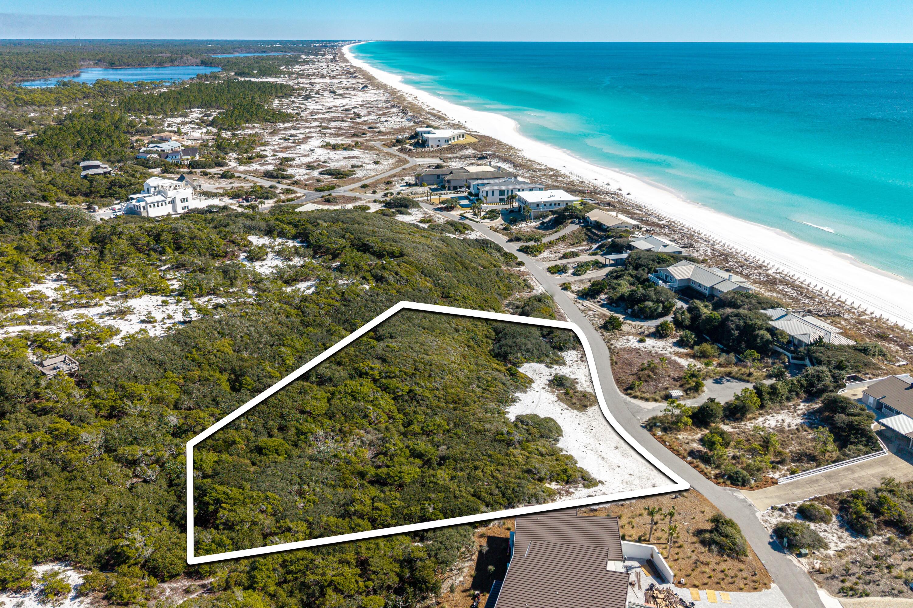 Elevated one-and-a-half-acre homesite with sweeping Gulf and sunset views in the private community of Four Mile Village.

Located just one row off the Gulf, this exceptional lot offers expansive views of unspoiled beaches and the Gulf beyond. The property is surrounded by native vegetation and mature coastal plantings, providing a peaceful and private setting.

Four Mile Village is a quiet, established coastal community located just west of Sandestin's shopping and dining. Known for its preserved sand dunes, canopied oaks, and approximately 2,200 feet of low-density beachfront, the neighborhood was founded in 1976 with a focus on privacy, conservation, and long-term preservation. Situated within the 230-acre Coffeen Nature Preserve, the community supports protected wildlife, including white-tailed deer and gopher tortoises. Architectural guidelines and height restrictions are in place to maintain the natural character of the area and protect long-term Gulf views.