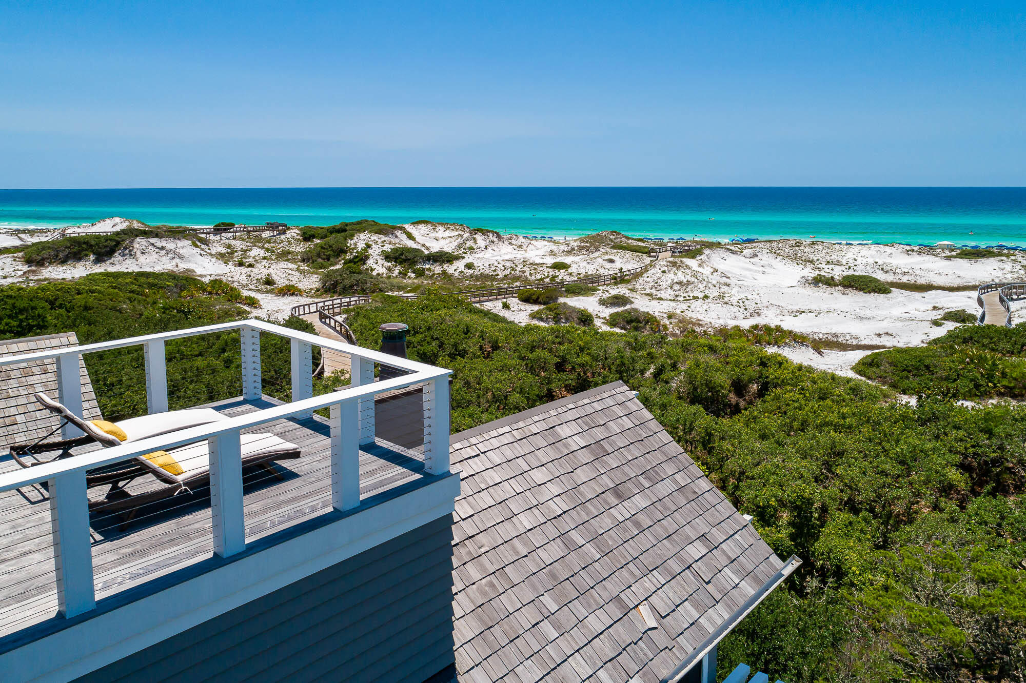 Poised Gulf-front in the gated community of Watersound Beach, 114 S Watchtower Lane boasts quintessential coastal living. Situated on the iconic sprawling dunes, this immaculate beach home with private pool is just steps from the beach and a short bike or golf cart ride to the coveted Watersound Beach Club. A talented and renowned team, comprised of architect Tyler Doin and builder Regal Stephens Construction, created the ideal luxury beach house, exuding a high level of elegance while maintaining the natural elements of comfortable coastal design. Four spacious floors feature numerous balconies that provide breathtaking views of the sugary sands and crystal clear waters of the Emerald Coast.

Upon entering through the custom Mahogany doors, you are well greeted by a tall foyer with grand staircase, calacatta gold marble flooring and v-groove wood paneled ceilings. An elevator provides convenient access between levels. Continue from the foyer into the interior pool room with wet bar and exit the french doors to the pool deck. The peacock paver pool deck is situated along the west side presenting a chic infinity pool flanked with fire bowls. The pool deck connects to a covered deck along the south side, which houses the summer kitchen and spiral staircase leading to upper decks, complete with ipe decking. Three guest bedrooms, with full baths, are housed on the first level, one being a junior master, located along the south side, dune-front. The second level boasts a fully appointed chef's kitchen with calacatta gold marble countertops including a cascade waterfall island, a striking glass tile backsplash, a custom designed hood, and high-end appliances. The kitchen is open to the living area overlooking the gulf, with custom stone fireplace and doors opening to the covered deck with additional fireplace. Two additional guest rooms, with full baths, are housed on the second level, one of these being a large attached guest suite above the garage, which includes the opportunity to add on a sellable golf cart. The guest suite features a morning kitchen and private door and stairway. Mount to the third level fully dedicated to the master suite, with morning kitchen and a separate office and lounge room. Gulf views expand at this level. The deck conveys access via another spiral staircase up to a fourth level deck for exceptional expansive sunsets over the gulf. Come discover luxury coastal living at 114 South Watch Tower Lane in WaterSound Beach.