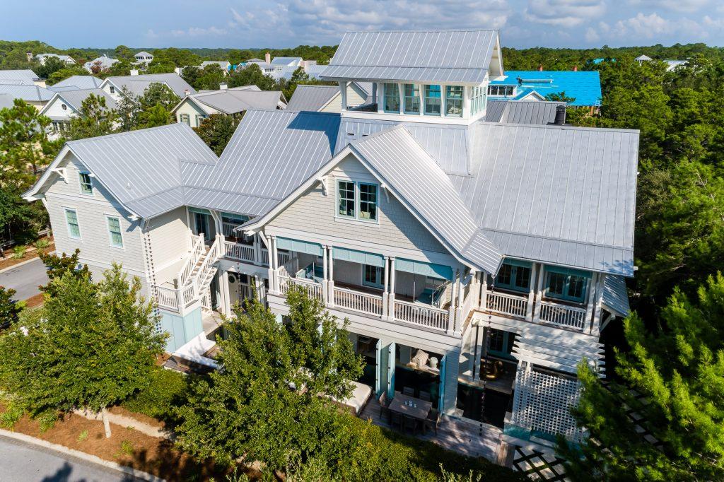 Situated on a prime corner site within the popular, amenity rich community of Watercolor, Florida, this exquisite 3-level luxury residence, with stunning custom designer pool and carriage house, presents coastal living at its finest. This spacious beach home is set in the quiet retreat of Watercolor's Phase 3 community and is luxury defined! The home is encased in a multitude of wrap-around porches that are surrounded in coastal native magnolias and scrub oaks. Transition from the porch and step off into your moat of a pool and leisure the day away. The soft gray shake exterior with cream and soft aquamarine trim is carried throughout the house. Bronze gas lanterns on the porches and faint blue interior ceilings nod to southern tradition... The exquisite familial retreat boasts spacious, main living areas perfect for entertaining. This grand home invites the openness with floor-to-ceiling glass sliding doors and a sea of windows. Fine craftsmanship in this home is enhanced with sea pearl interior wood walls, exquisite marble countertops with brass and copper finishes highlighting this gourmet kitchen. If looking to maximize rental return on investment, this home is suited to be a rental giant with sleeping accommodations for 20. Offers partially furnished, the residence is superbly maintained. The attention to detail is remarkable! Upscale amenities include hurricane impact windows, ADT with 10 cameras, Sub-Zero and Wolf appliances, 1500 square feet of the finest quality decking, guest house and 2-car garage with a loft. This unique home located in WaterColor's Lake District backs up to a natural preserve with meandering walks and is just steps away from the Sand Hill pool and park. Enjoy a short walk across the Western Lake pedestrian bridge to the Boat House, whimsical "Frog Pool," sprawling Cerulean Park North, Town Center, and gulf front Beach Club as well as the  shimmering Emerald waters of Gulf of Mexico!  Sleeps 20. Buyer to verify all room dimensions and square feet of home.