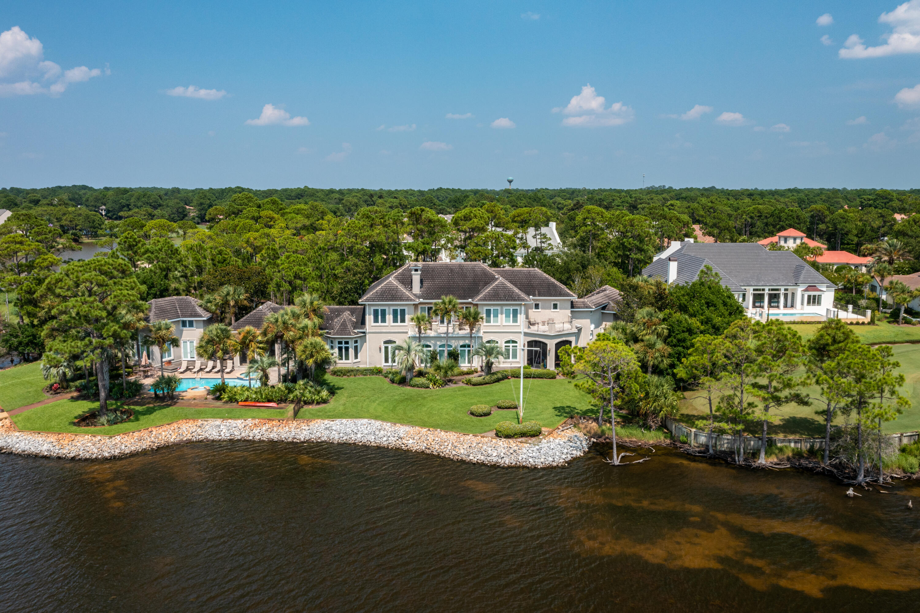 Sitting on almost one acre and bordered by The Choctawhatchee Bay, and 13th and 14th hole of Burnt Pine Golf Course, 3257 Burnt Pine Cove is a  magnificent estate that offers privacy and views that can not be found anywhere else in Sandestin Resort.  Measuring 8856 sqft, the main home features 6 bedrooms, 5 full baths, 2 half baths, chef's kitchen complete with butler's pantry and double dish washers, expansive living area, two dining rooms, media room, office, library, two laundry rooms, 3 car garage, and elevator.  The separate guest house adds an additional bedroom, 2 full bath, kitchenette, and living area.  The outdoor space is sure to not disappoint with 376ft of waterfront, heated pool and spa, two screened  porches, private dock with boat lift and two jet ski lifts. With all of these features as well as the world class amenities Sandestin has to offer, its easy to see why this is considered to be one of the premiere properties along The Emerald Coast.