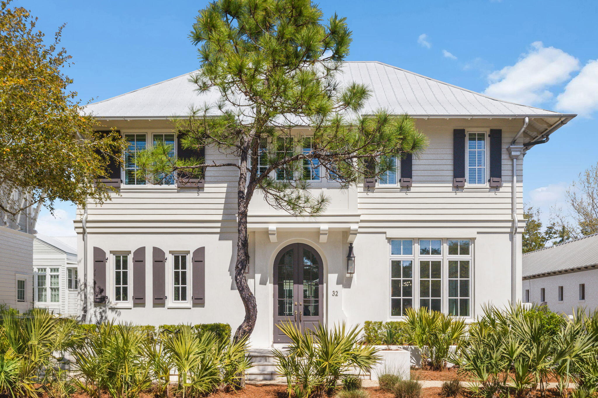 Live the Rosemary Beach dream in this stunning 4-bedroom plus bunk, 5.5-bath coastal retreat, built in 2017 and standing out as one of the newer homes in this coveted community. Thoughtfully designed with style and comfort! The private courtyard is your personal paradise, featuring a heated pool and a sleek outdoor lounge with a summer kitchen  perfect for easygoing afternoons and evening gatherings. You can access this outdoor oasis from the great room, kitchen, and primary suite, making indoor-outdoor living a breeze. Step through the grand mahogany door and feel the coastal charm. The lower level features polished concrete floors, crisp shiplap walls, and coffered ceilings that set the tone for laid-back luxury. The open floor plan flows effortlessly from the great room to the dining area and into the chef's kitchen, where Carrara marble countertops, custom cabinetry, and high-end Thermador appliances including a double oven with a six-burner gas grill and griddle make cooking feel like a treat.
Just off the kitchen, you'll find a spacious laundry room, a cozy guest room with an ensuite bath, and the dreamy primary suite. Vaulted ceilings and a spa-inspired ensuite with double vanities, a soaking tub, and a walk-in shower make this space a true retreat. And don't forget the custom walk-in closet because beach life needs a lot of outfits.
Head upstairs to find wire-brushed oak floors leading to two more spacious bedrooms with ensuite baths, a charming bunk room with barn doors, and a cozy media area perfect for movie nights after a long day at the beach. Carrera marble and designer tile work in every bathroom keep the whole house feeling fresh and stylish.
Rosemary Beach is more than a place it's a vibe. Stroll down the brick-lined streets, grab a coffee from a local café, or explore the boutique shops and beachside eateries. This is the kind of coastal living that people dream about and it could be yours.
Don't miss out on this one homes like this don't come around often!