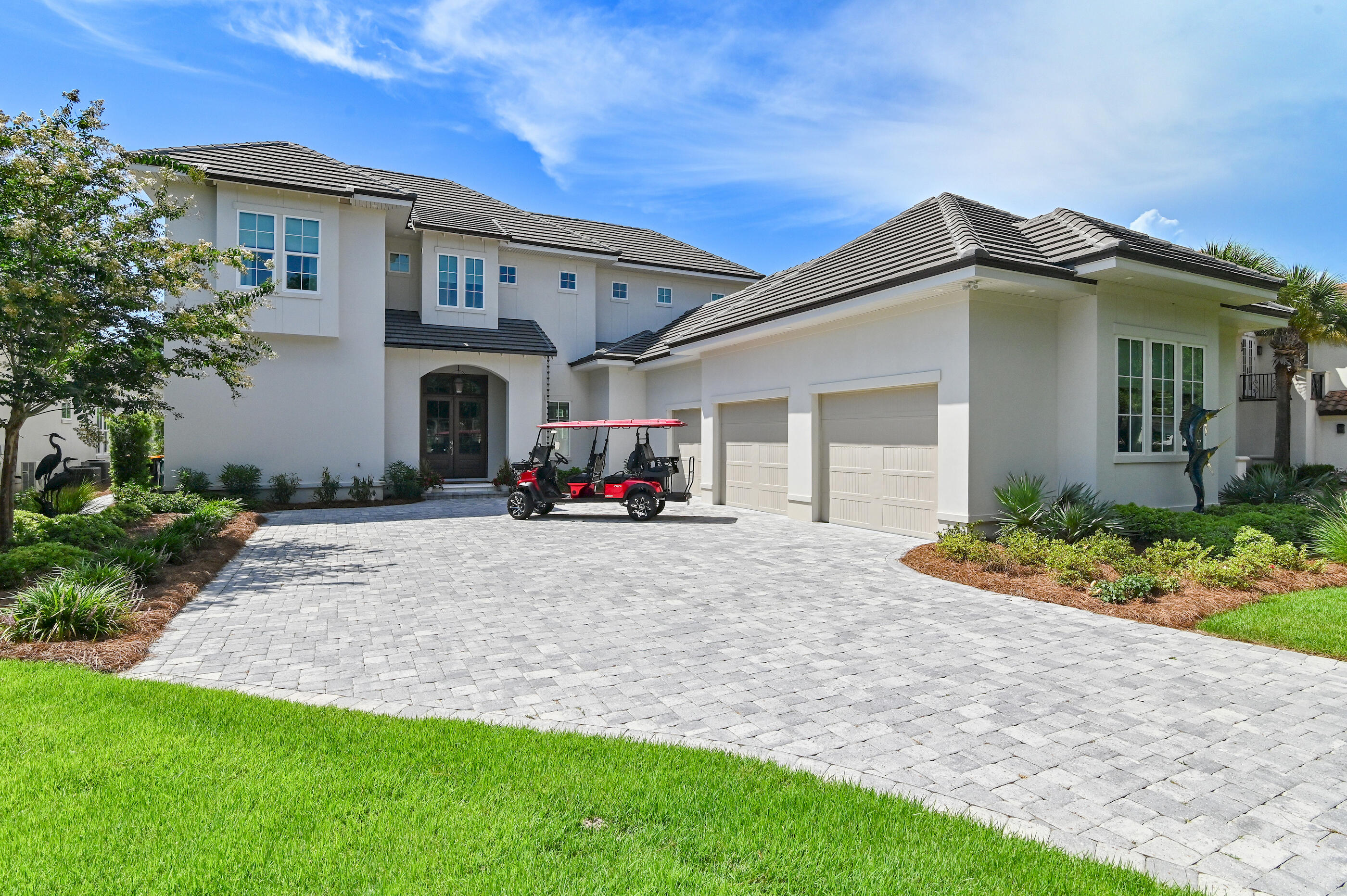 Welcome to 298 Corinthian Place, where elegance meets tranquility in this prestigious gated community of Regatta Bay in Destin, Florida. This custom-built masterpiece offers a premium lot on the 13th hole of the golf course, complete with a serene pond view, catering to the discerning buyer seeking luxury, privacy, and breathtaking vistas.



As you approach, the home's striking facade and meticulously landscaped grounds offer an immediate sense of grandeur. Step inside to discover the expansive entryway, seamlessly connecting you to the main living areas where high ceilings with Solid wood beams lending a transitional touch, blending classic and modern elements effortlessly. There is and abundant natural light with auto shades with a dramatic lake views. The gourmet kitchen, a culinary enthusiast's dream, with a Wolf gas stove and custom curated  hard wood hood with  impact, SubZero Refrigerator, Scotsman Ice maker, wine refrigerator, bespoke cabinetry, and extensive counter space, with double quartzite islands, and private walk-in custom Pantry. Perfectly designed for both intimate family gatherings and entertaining.

Retreat to the sumptuous primary bedrooms, each thoughtfully designed to provide a private sanctuary, while the spa-like bathrooms offer a haven of relaxation with their luxurious tiger striped porcelain tile finishes and chrome fixtures. The primary suite features a walk-in custom tiled shower, a large soaking tub, double vanities, and a dynamic walk-in closet with access to the laundry room.
The outdoor oasis is unparalleled, with a stunning pool, spa, and lounge area perfect for unwinding while enjoying the sunset over the lake and 13th hole. This space is designed for both relaxation and entertainment with an outdoor kitchen, dining area, outdoor media nook, and retractable sunshield screens providing an idyllic backdrop.

Top Visual Selling Points 

1. Gated Community one of the top-rated golf courses along the Emerald Coast of Florida

2. Premium lake front and 13th hole golf course views

3.  Custom builder ~ Legacy home builder

4. Stunning outdoor pool and entertainment area with sun shield screens

5,. Spacious, light-filled interiors with high ceilings and natural beams

6. Gourmet kitchen designed for culinary excellence, double quartzite counters, butler's pantry, dual sinks and prep areas, private walk-in pantry

7 Full house, generator heated and cool garage with lift, paver sidewalk along utility area on the side of the house.  

8. The primary suite features a walk-in custom tiled shower, a large soaking tub, double vanities, and a dynamic walk-in closet with access to the laundry room.