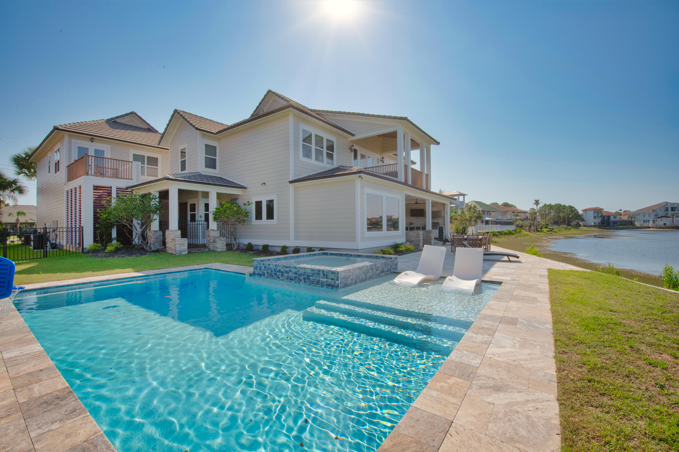 Introducing an exclusive opportunity to experience waterfront luxury in the prestigious community of Destiny East. This breathtaking property, built in 2005 and extensively renovated, is nestled on the tranquil Four Prong Lake, offering a generous 110 feet of serene waterfront and captivating views of both the lake and the enchanting Gulf of Mexico. Spread across 4,579 square feet, this magnificent estate harmoniously blends function and aesthetic, with an open layout that allows for seamless movement between spaces and takes full advantage of the mesmerizing views. The high ceilings and expansive windows create an airy, light-filled atmosphere that highlights the elegant finishes and meticulous attention to detail.The main house boasts 5 well-appointed bedrooms, including a lavish master suite that offers spectacular views of both the lake and the gulf. A stylishly renovated kitchen, large family area, and grand dining space with unobstructed views complete the luxury offering in the main house.

In addition, an opulent guest suite sits above a spacious 3-car garage, featuring a full kitchen, dining room, full bath, and 2 comfortable bedrooms, ideal for accommodating visitors or serving as an additional income source.

Outside, a brand-new pool area and outdoor grill invite you to enjoy alfresco living at its finest. The sweeping vistas of the emerald green waters and pristine white beaches seem to blend with the outdoor space, creating the perfect backdrop for relaxation or entertaining.

This property is located within a friendly biking and golf cart community, offering private access to the gulf and its stunning white sand beaches. It's not just a vacation spot, it's a lifestyle, a private paradise in a coveted area, currently utilized as a short-term vacation rental with gross rental projections exceeding $180k-$198k.

Come and explore the opportunity to own a piece of waterfront heaven where every day feels like a vacation, and every moment reminds you of the beauty of coastal Florida living.