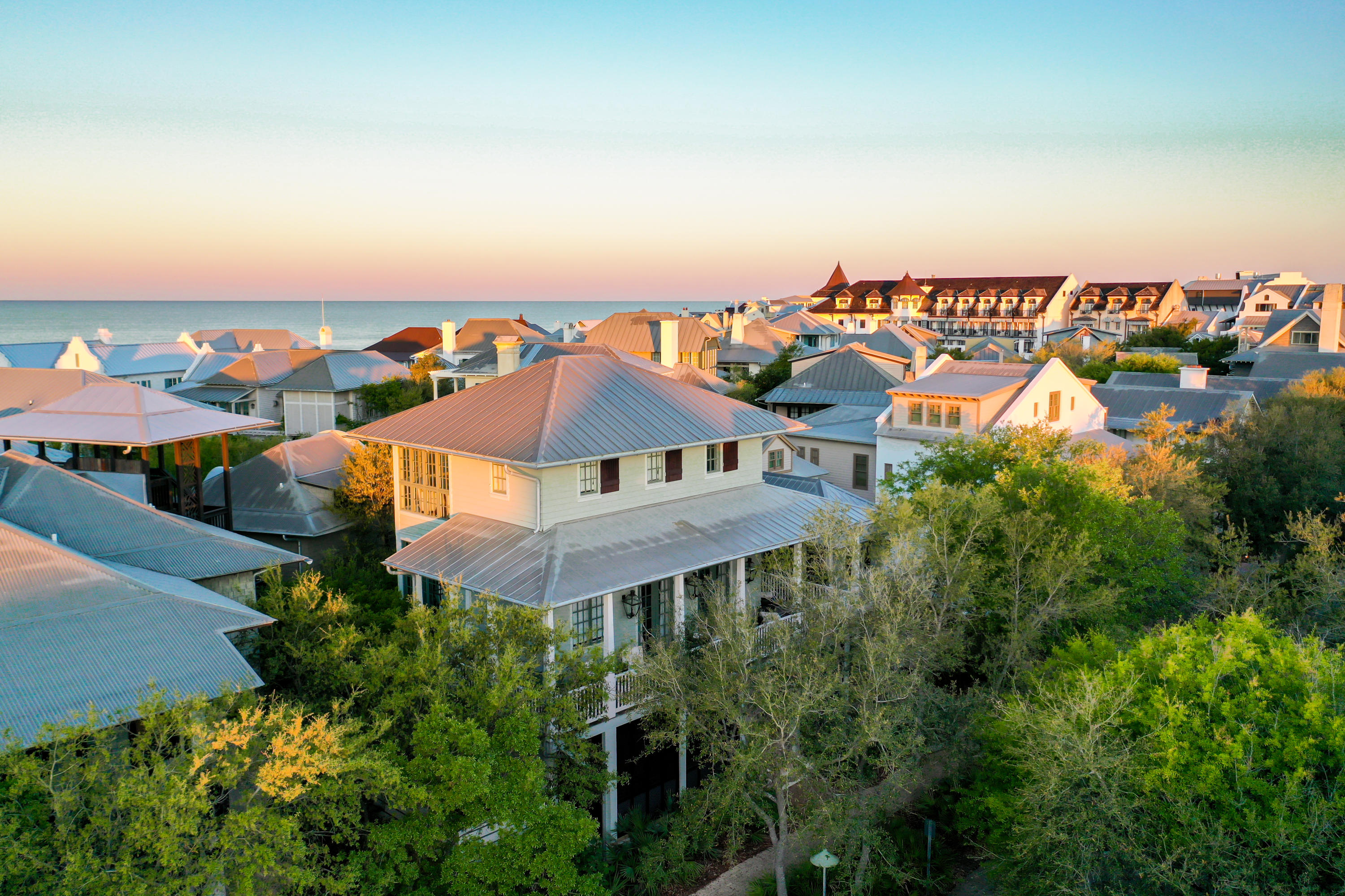 This beautifully renovated and updated Rosemary Beach gem is offered complete with designer furnishings. Lower level boasts a bedroom with ensuite bathroom and access to the front porch with swing and sitting area. There is a second large bedroom with a sitting area and access to the expansive courtyard. Also on the lower level, a second full bath, and a charming nook with a single bed.
The main living area is found on the stunning second level with soaring ceilings and floor to ceiling windows for picturesque views of the gulf. A gourmet kitchen with stainless Thermador appliances and a spacious elegantly appointed living area are perfect for entertaining and relaxation. A full bath with a stacking laundry unit area is also found on the second level. The third level is comprised of a master retreat complete with a spacious living area with wet bar, large spa-like marble bathroom, and a gulf view patio. There's a separate sitting area that could be used as an office with breathtaking gulf views.
Above the single garage, and adjacent to the wrap around porch, you find a large screened-in porch with wet bar and nearby gas grill providing additional relaxation and entertaining space.