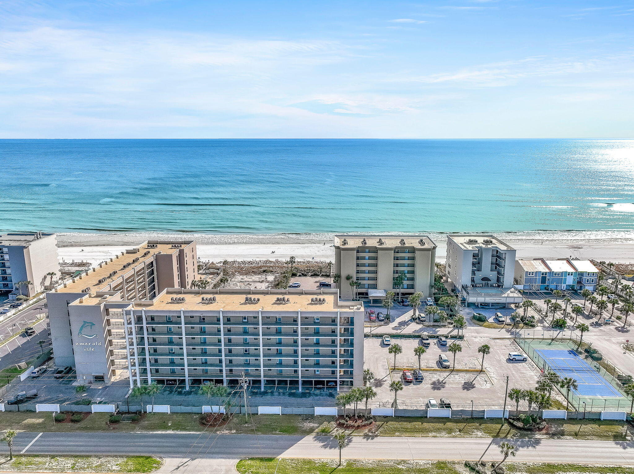 Welcome to Emerald Isle 208 -- a luxury Gulf-front end unit beach retreat w/ private parking space - located on beautiful Okaloosa Island. This impeccably maintained 2BR/2BA residence has been thoughtfully upgraded and professionally styled to deliver the perfect blend of coastal elegance and modern comfort. From the moment you enter, your eyes are drawn to the stunning shiplap feature wall that anchors the living space, creating a refined yet relaxed beach aesthetic.

The open-concept living area flows seamlessly onto an oversized, due-south-facing balcony -- a rare and highly desirable orientation that offers endless, unobstructed Gulf views and sun-drenched days year-round. Whether you're enjoying your morning coffee at sunrise or winding down with a glass of wine as the waves roll in, this expansive outdoor space is designed for true Gulf-front living.

The fully remodeled bathrooms showcase beautiful finishes and elevated details, while newer furnishings throughout the condo provide a fresh, luxurious feel. The kitchen is well-appointed and ready for entertaining, featuring everything needed to prepare a sunset dinner after a day on the beach.

Sleeping Accommodations:

Primary Suite: King Bed with private bath

Guest Bedroom: Two Full Beds

Living Area: Sleeper Sofa

(Comfortably accommodates up to 6 guests.)

Emerald Isle is a beachfront complex offering direct access to the sugar-white sands and emerald waters of the Gulf. The beachside pool overlooks the shoreline and includes a convenient ramp for easy beach access. The pool deck features ample lounge seating and grilling areas, perfect for relaxed evenings by the water.

From the western side of the property, enjoy views of the Destin Sound -- part of the Intracoastal Waterway -- where yachts and fishing vessels glide past against a stunning coastal backdrop.

Ideally located just minutes from dining, shopping, and entertainment in Fort Walton Beach and a short drive to the vibrant harbor district of Destin, you're perfectly positioned to enjoy the best of the Emerald Coast. Spend the day at Gulfarium Marine Adventure Park, cool off at Big Kahuna's Water & Adventure Park, or fish from the nearby Okaloosa Island Pier.

Whether you're seeking a luxury second home, an investment opportunity, or your own private Gulf-front escape, Emerald Isle 208 delivers elevated coastal living with breathtaking views in every direction.