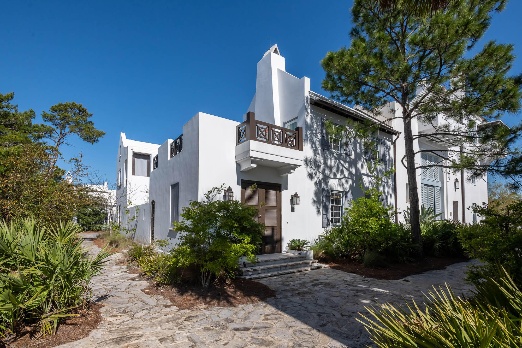 Architect Floyd McCollum created the quintessential Antiguan influenced home that Alys Beach personifies.  This courtyard home is situated on a corner homesite featuring 3 bedrooms & 3.5 bathrooms of which one is a private Casita having its own roof terrace perfect for sunning & star gazing by light of the terrace's fireplace.  
The home surrounds a southern facing private courtyard with pool & dining loggia.  All common areas of the home have views of this private outdoor space which transfers natural light from outdoors to in.  The 1st level is all common area connecting the kitchen, dining, and living room, with fireplace, making for an environment to gather.  
The kitchen features professional appliances centered with a large island looking upon the dining & living areas keeping the commons areas adjoined.  Outdoor dining is achievable having the outdoor covered loggia steps from the kitchen with its own dining table by the pool.  
46 Butter Wood Alley primary elevation fronts the award-winning Sea Garden Walk pedestrian path creating a special environment for guests to enter the home and for easy pedestrian travel to the private owners Beach Club, the Caliza Pool, and Zuma Wellness Center.  North to Lake Marilyn & the nature preserve or south to the beach by way of Sea Garden Walk.  
The primary bedroom hosts an eastern facing private balcony looking upon the courtyard & pool quiet for reading and morning coffee.  This room offers a separate closet & dressing room located adjacent to the en suite bathroom.  East & West windows allow for transition of natural light throughout the day.
Opposite of the primary bedroom is the very generous guest bedroom with en suite bathroom.  This room is furnished with a king size bed and complementary furnishings for longer visits.  
Additionally, this property provides two-single car garages having a total of 4 storage closets for beach accompaniments and the like.  Furnishings are to convey with the sale.  This home is a must see and ready for occupancy.