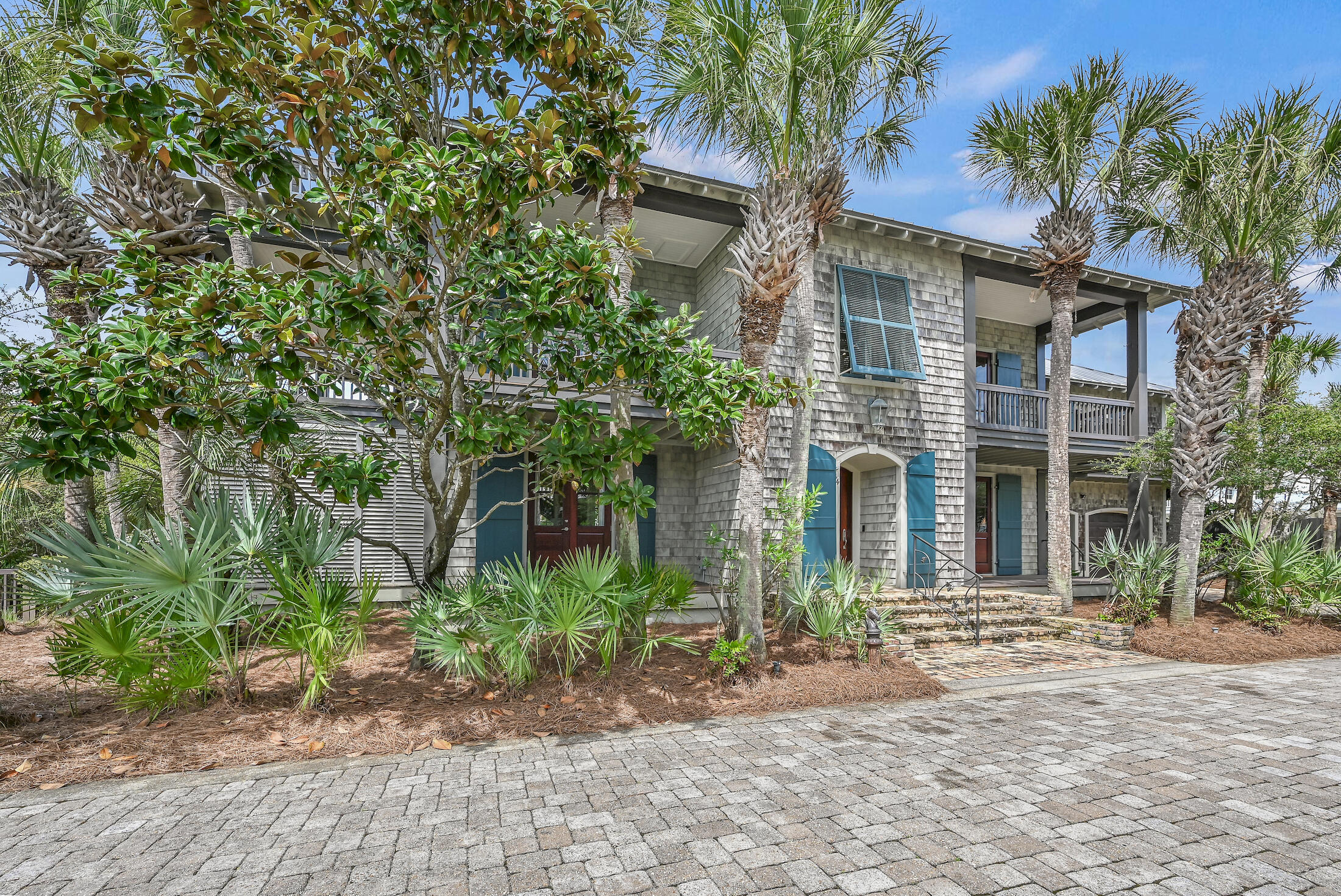 Compelling New Price!!!  Rare opportunity South of Hwy 30 A, one lot off the Gulf, with deeded beach access and no short-term rentals. This Southern Coastal home was designed and built by Café Thirty-A's renowned restaurateur. With three bedrooms, three baths, and 3,391 square feet on a beautifully wooded and landscaped lot, it's a paradise for both nesting and entertaining. Enter through the large first-floor foyer, and you are greeted on the right by an office with built-in book shelves and an entry door to the large two-car garage. Continue through the foyer into the library, also with built-in book shelves and a doorway to the first-floor wrap-around deck. The library divides the two downstairs bedrooms, both with ensuite baths and one with a walk-in closet. The Southern bedroom opens to the wrap-around deck with an outside shower and cabana. Up the curved staircase to the second floor and the huge living room/dining area filled with light and Gulf views. The second-floor multiple porches and decks are great for morning coffee, al fresco dining, or that afternoon cocktail and are easily accessed from the living room and dining area. The living room is open and spacious, with beautiful hardwood floors, a coffered ceiling, and a wood-burning fireplace with a gas lighter. The kitchen just off the dining area has a small breakfast bar, stainless appliances, a professional six-burner gas stovetop, a double oven, an ice machine, and plenty of cabinets. Just off the kitchen is a pantry with more cabinets and a chef's office workspace. The pantry opens to an outside deck with stairs leading to the beautifully landscaped yard. Off the kitchen is the primary bedroom with an en-suite bath with oversized soaking tub, separate shower, and two separate vanities and toilets. Exiting the bath from one of the separate vanity areas is a large bonus room with two spacious walk-in closets, a built-in closet for the full-size washer and dryer, and plenty of extra space for a hobby area, home gym or could be made into a quiet reading area. The bedroom opens to the deck, where you can head up to the third floor and the large rooftop deck with amazing Gulf views and cool breezes. What a way to start, finish or just enjoy the day in this wonderful outside oasis.