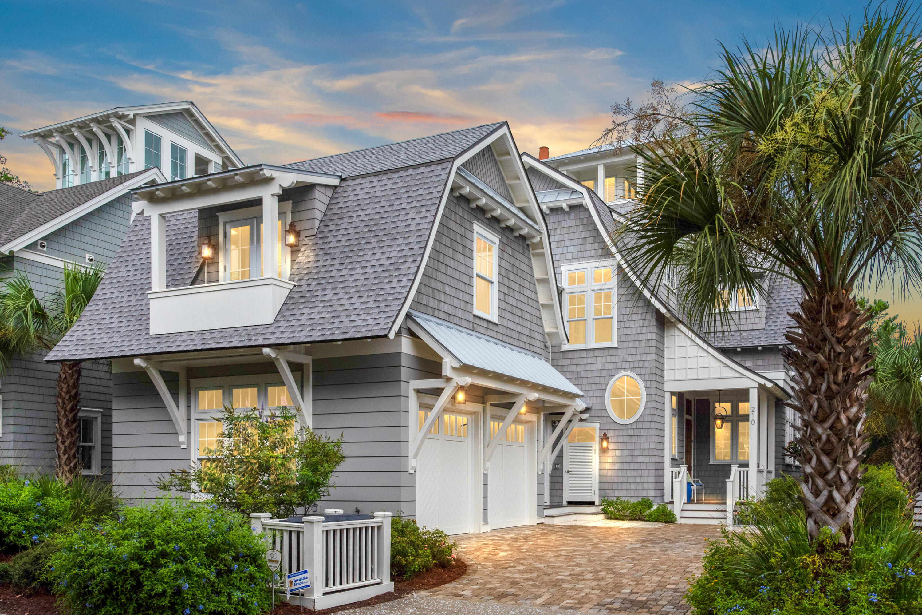 This luxury beach house breaks with conformity to offer a refreshingly modern home with outstanding design features. Hand-scraped hardwood flooring and 12-ft. ceilings grace the living area along with an open fireplace. Look up to admire the reclaimed beams in the family room and cathedral ceiling in the master bedroom. Pristine white decor and full-height windows create a light contemporary dining space with pool and tree views. From the mahogany front door to the gourmet kitchen, there's an upscale tone. Custom cabinets contrast with gleaming white quartz countertops that flow onto the expansive breakfast bar. Chefs will appreciate the Wolf and Sub-Zero appliances, warming drawer, walk-in pantry and central island while hosts will appreciate the wet bar with ice maker and drawer refrigerators storing everything to hand.
A NanaWall seamlessly connects the living room with the screened porch providing a serene outdoor space for relaxing with family and friends. It overlooks the tidal pond with its visiting birds and wildlife. The private courtyard pool with remotely operated fountain makes an eye-catching feature as well as a place to enjoy a refreshing swim. Six beautiful bedrooms coddle guests in luxurious surroundings and Sealy mattresses ensure a sound night's sleep. A wooden barn door provides access to the bunk room from the second sitting area. Climb the spiral staircase to the lookout for the best views of this exclusive coastal community.
This opulent beach house has many extras including a central vacuum system, dehumidifier, water filtration system, cell phone booster and Sonos sound system throughout the home. The field-sized garage has tons of storage for bikes and beach gear along with two electric car chargers.