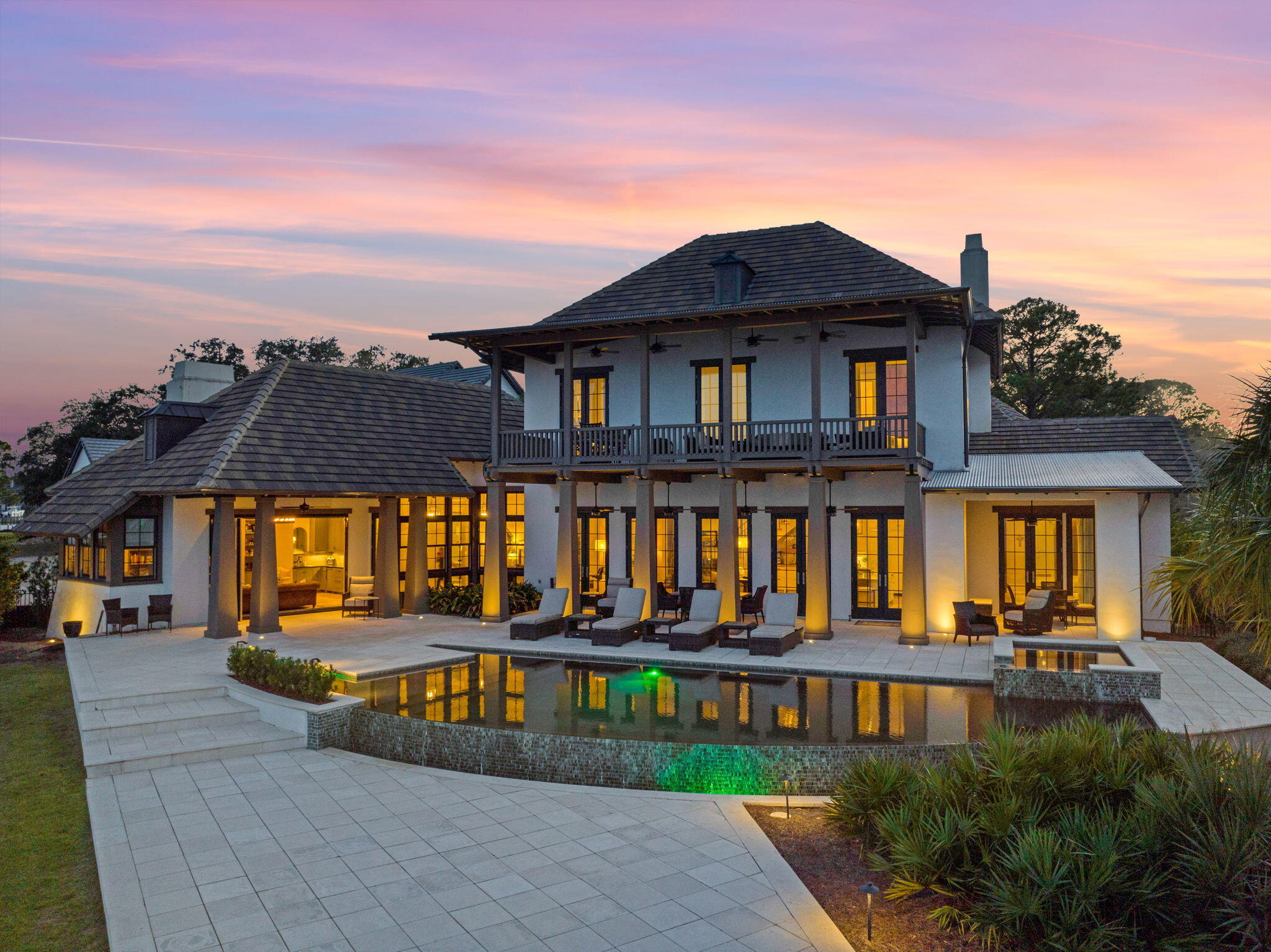 Tucked away at the extreme east end of Indian Trail, the private cul-de-sac location of this Matt Savoie-designed residence ensures peace and privacy within the gated Estates at Indian Pointe on a 0.67 acre lot overlooking the Choctawhatchee Bay. Designed with many one of a kind features, the home is planned around a gourmet kitchen featuring Calcutta Gold marble countertops and top-of-the-range appliances including a Wolf oven and range, Sub Zero refrigerator, and Bosch dishwasher. The living room has 12-foot ceilings and adjoins the formal dining room. A comprehensive primary suite occupies the remainder of the first floor's north wing with Turkish Patara limestone counters, Akdo tile, and Palladium travertine flooring in the adjoining primary bath. The media room, just to the side of the main area is ideal for entertaining and includes a fireplace, wet bar, ice maker, hidden drawer refrigerators, and a powder bathroom. It also boasts an entire wall of bifold French doors opening to the back of the property's private, heated infinity pool, hot tub, covered porches, as well as a fire pit, and priceless views of the bay. The interior courtyard provides a natural green focal point, while the garage is accessed by a convenient covered breezeway. The oversized 3 door (2 full size car plus golf cart/compact vehicle) garage features mahogany wood doors and ample storage space.
The second floor is devoted to three additional bedrooms, each with en-suite bathrooms. All bedrooms upstairs enjoy beautiful views of the water with access to the upper porch from every room through storm grade French doors. Owners will enjoy unsurpassed boating, fishing, and luxury waterfront living from the 154 feet of private waterfront that this highly desirable lot affords. A custom built dock was added to the property in 2021. No expense was spared selecting top of the line materials including over 1,000 square feet of ThruFlow decking panels that cover all walkways, decks, and platforms. The walkways are lined with total under dock lighting and each piling is encompassed with LED lights to create a custom, unbelievable effect like no other - all from the touch of a remote with endless colors from which to choose! The slip with a lift was built to accommodate a 47' Freeman and the outer slip along the seawall will fit just about anything that floats in 5' of water with the channel just a few yards away. There is also a third slip area for small vessels equipped with all new lifts. An additional paddle board dock/swim platform is attached, along with a beautiful gazebo where you can sit and watch everything from Redfish to Dolphins pass under the Choctawhatchee Bay. Nearby Harborwalk Village puts high-end dining, shopping, seasonal entertainment, and chartered fishing expeditions within easy reach of this unique bay-front home.

***Available to purchasers is an additional 0.76 acre adjoining lot with a total of 300+ ft of private waterfront ensuring complete and total seclusion. These combined properties not only boast the largest square feet of water-frontage, but also the best all around view The Estates on Indian Pointe offers.