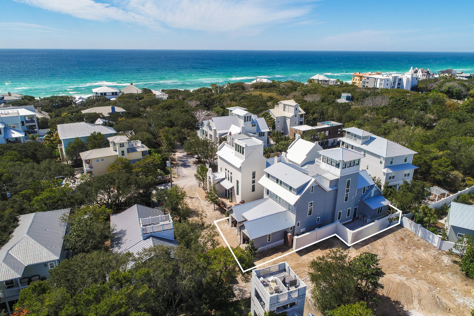 NEW CONSTRUCTION just completed in December 2018! Luxury fit & finish! Seller has furnished first floor (living & master br)! Offering fabulous Gulf views from one of the highest elevation points in Old Seagrove, this luxurious new construction home, designed by Matt Savoie and built by Alex Rice, is now complete. Leaving no detail unturned, this 5,275 square foot masterpiece has everything you would expect in a new $3M home: Five Sub-Zero refrigerators & four wet bars, one on each floor! Blue Star gas stainless range, security system w/ 8 cameras & Sonos wireless sound system. Exterior is 1'' cedar plank with stained dead-head Cypress soffits, TuffMax Rib metal roof, JeldWen high impact windows and accordion doors at poolside with two courtyards, one built around a gunite heated pool and one built around an outdoor kitchen with fireplace and..antique brick floor, and quaint tabby chimney. All bedrooms will fit a king bed, and bathrooms include Carrera marble floors and showers. White oak 6'' plank floors throughout, and all interior and kitchen cabinet doors are pecky cypress.  Conveniently located steps away from local Seagrove/Seaside restaurants and shopping, and the beach access is just one block down Azalea St!