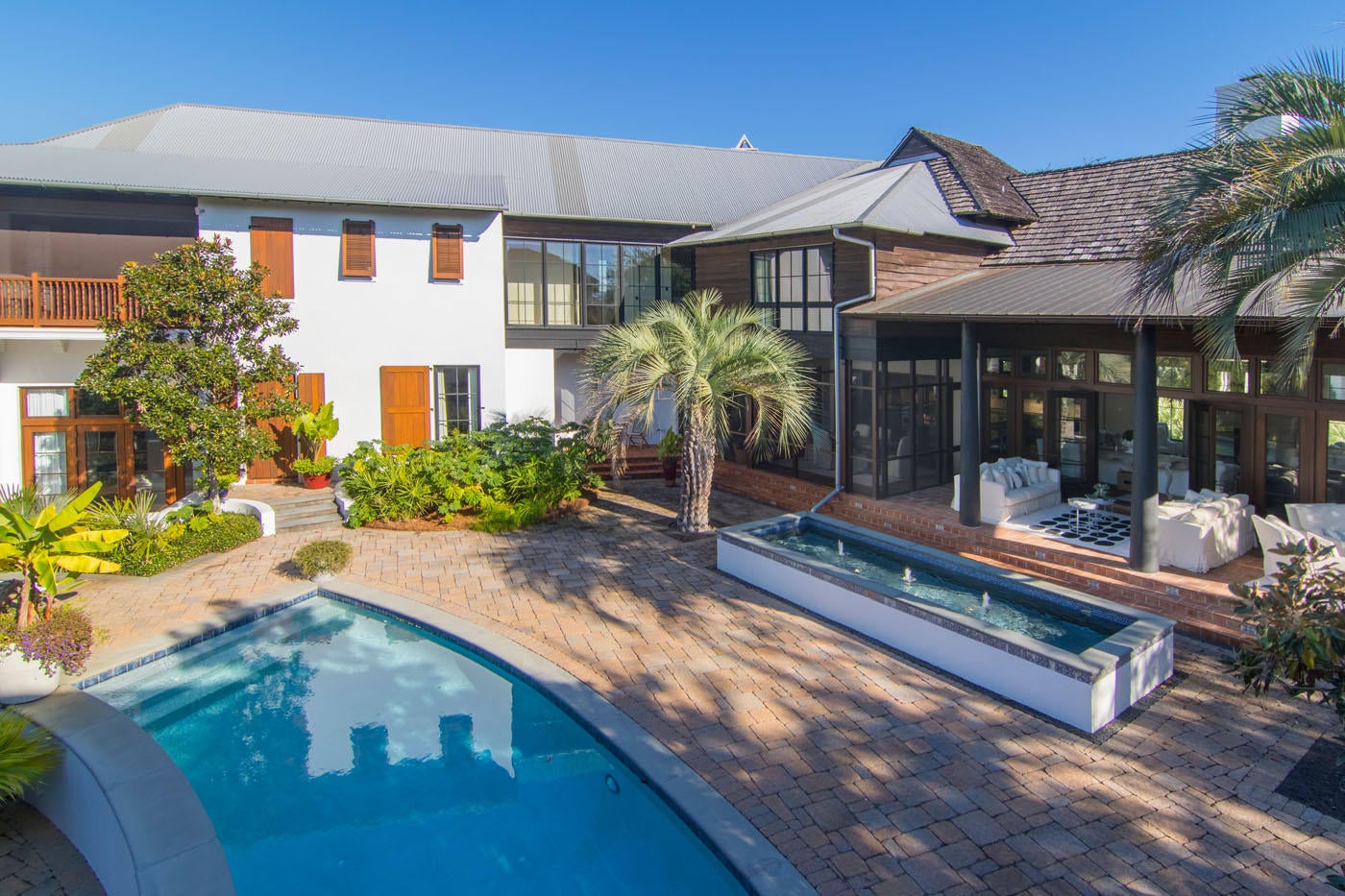 Sitting on the largest lot in Rosemary Beach, this grand custom villa is like no other in the community. Designed by Darrell Russell, principal architect at A Boheme Design, this property exhibits a Mediterranean inspired design with hints of Old Havana. With more than 6,000 square feet of custom indoor and covered outdoor space, this home was built for full-time livability that comes with large rooms, custom finishes and ample storage and closet space. Indoors, the expansive living/dining room and kitchen features newly painted walls, new cabinetry and marble counters, oversized island, vaulted wood ceiling and stone floors. The custom kitchen includes custom cabinets, Sub-Zero refrigerator, wine cooler and ice maker, Wolf range and double oven, and two Fisher & Paykel dishwasher drawers. Lighting, sound, climate control, security system and cameras are all at your fingertips with a state-of-the-art Creston Home Automation System. Also on the main level are two powder baths, a home office and luxurious guest suite with separate entry from exterior courtyard. In addition, a large media room is accessible from the exterior courtyard or the upstairs master suite.

The second level features custom wood floors and abundant casement windows to view the beautiful grounds below. The master suite includes a large bedroom, oversized master bath with hand-made tile and his/her shower, three walk-in closets and an outdoor porch with a remote-operated screen. Also on the second level are two guest bedrooms with a large bath and walk-in closets, adjoining media room and huge laundry room. The Carriage House, with a two-car garage, features a first-floor pool bath, outdoor shower and upstairs guest suite with large bedroom/sitting area, bunkroom and bath. 
Outdoors is an oasis where rambling paths and a babbling brook welcome a stroll through the quarter-acre yard, featuring a large swimming pool and custom playhouse.
This beautiful home is located on the park side of Rosemary Beach, just a short stroll to the Owners Pool & Pavilion, the Town Center and multiple beach accesses, yet far enough away for quiet enjoyment in your own private resort villa.
The amenities of Rosemary Beach include a vibrant Town Center with shops, restaurants, post office and Town Hall as well as Parks and 5 heatable Pools, one of which is an indoor pool with a retractable roof and the recent addition of the Private Owners Pool & Pavilion and the signature 9 Boardwalks that meander through the Town and all lead to a half mile of sugar white sandy Beach!