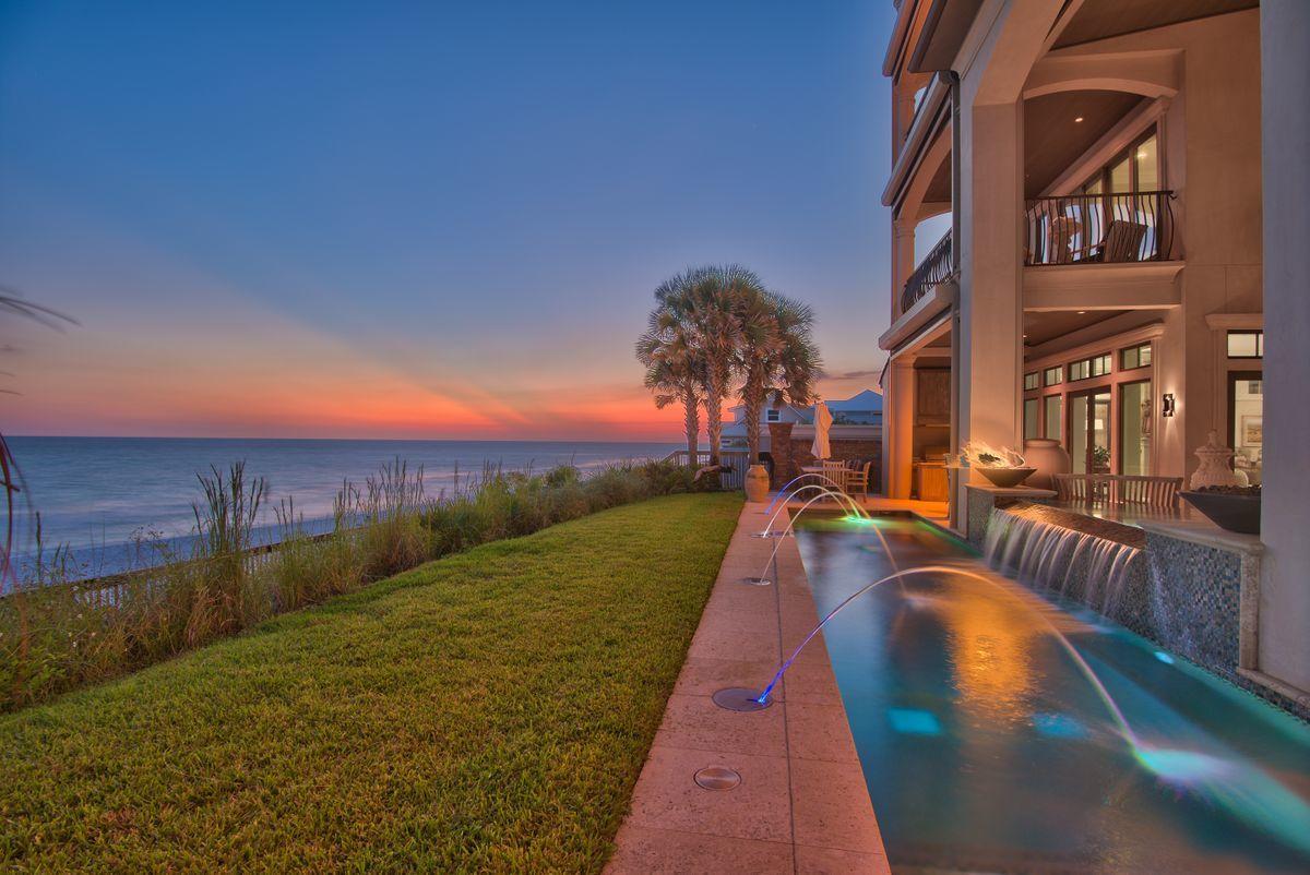 Nestled atop a pristine bluff on Blue Mountain beach and presiding over 75' of beautiful gulf frontage, this expansive coastal retreat exemplifies privacy with it's compound nature and palatial architectural design. The sprawling compound generously provides over 8,200 square feet of premium living space notably characterized by elevated engineering & superior building methods including brick masonry & stucco over insulated concrete which was completed by esteemed Davis Dunn Construction. The open floor plan is thoughtfully curated as a multi-generational family retreat featuring six large bedroom suites with the primary living, kitchen and dining primely positioned on the first level which also provides 180 degree views over the glistening emerald green waters of the Gulf of Mexico and direct access to the south facing private pool and adjoining spa. Entry to the estate is made through the 10' iron gate, surrounded by a brick masonry walled courtyard offering both elegance & ample privacy with direct access to the parking court and oversized two car garage. Notable features include a whole home generator, LED lighting throughout, and a commercial elevator which provides direct access from the ground level to the third floor master suite. Residing on the entire top level of this multi-story beachtop manor, the owner's suite provides a true escape for those who demand the finest in craftsmanship, design, and unparalleled views of the Gulf of Mexico below. The master bedroom is oversized and is adjoined by a beautiful ensuite bathroom complete with dual vanities, soaking tub and walk-in shower as well as a spacious double walk-in closet with a private laundry and sun deck. The master sitting room and adjacent private office each have access to covered porches overlooking the pristine gulf waters. Other notable features include  an energy efficient geothermal system, foam insulation, private in-home theatre with digital surround sound and the latest in projection technology. 

The panoramic views afforded from the fourth floor observatory are unparalleled and solidify the unique opportunity in this gulf front estate. Blue Mountain Beach is widely known as the highest bluff along the Gulf Coast and provides a central positioning along 30A's famous scenic corridor with excellent proximity to Seaside, Watercolor as well as all of the world class restaurants, boutique shopping and local entertainment that South Walton offers.