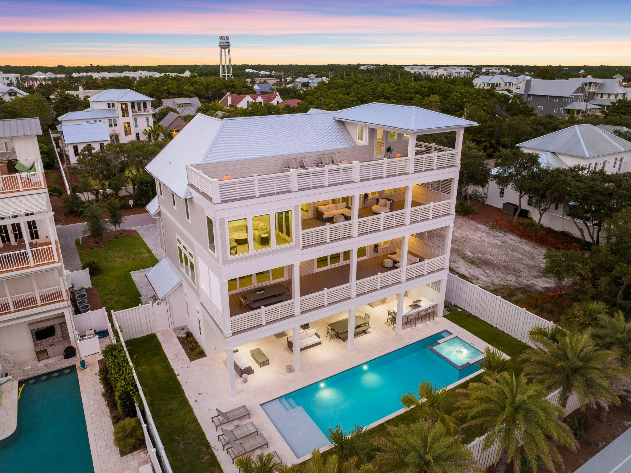 Welcome to your dream coastal oasis just steps from the shops and dining at Rosemary Beach and the friendly beach accesses in Inlet Beach. This magnificent 8-bedroom, 8-bathroom, and 2 half-bath residence spans an impressive 6,064 square feet of pure luxury living on a quarter of an acre. This home offers the perfect blend of tranquility and convenience.

One of the standout features of this property is its stunning 50-foot heated pool and spa, creating an immediate sense of relaxation and entertainment. As you drive up, the curb appeal is enhanced by a spacious 2-car garage, providing ample parking and convenience for you and your guests.

For those who love to entertain, the outdoor kitchen and bar complete with both a flat top and standard gas grill is a highlight.