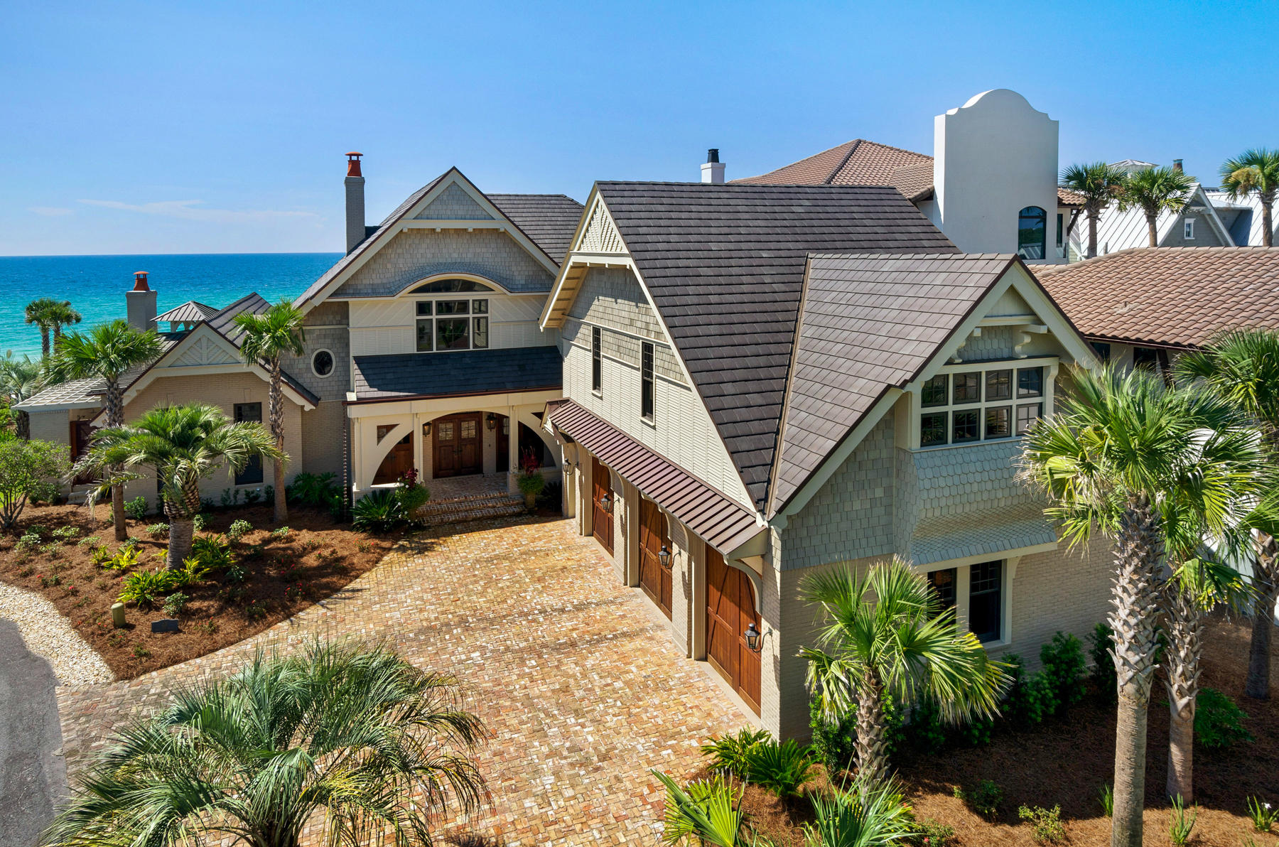 Presiding over 116 ft. of Gulf front this Seagrove residence embraces the essence of its surroundings with dramatic views from all angles. Expansive bifold glass doors stylishly and effortlessly open the living areas to the stone cover loggia and pool. On the loggia the stage is set for lounging by the infinity edge salt water pool, casual dining, or enjoying conversation around the fireplace and outdoor kitchen. Cleverly designed Jersusalem stepping stones over the pool lead to a more intimate raised hot tub with its own fireplace. Bevolo French Quarter gas lanterns add the finishing touch and ambiance to the outdoor living spaces. Cypress beams accentuate the main floor ceilings along with custom distressed cabinetry and an antique brick Rumford fireplace. When entertaining is a high priority an inviting kitchen is a must. The focal points in this chef's kitchen are a 9 ft. cypress island with concrete counter, 60" Wolf stove, butlers pantry with brew station and three Subzeros. The 1st floor master wing consists of his and hers bath leading out to individual, walled, outdoor showers. The master bedroom views enjoys both the gulf views and reflections from the 48 ft. pool. Walk in closets, custom built in cabinetry and a laundry area finish off the master wing. Rough hewn beams anchored by wrought iron plates and shiplap walls over looking the gulf bring a nautical feel to the 2nd floor 24 x 17 media room. Accessible to all the guests is a wetbar complete with dishwasher, beverage cooler and microwave. 
Besides the master wing, the 5894 sq. ft residence contains three bedrooms in the main house with a bunk room and a separate guest suite with full kitchen, living bedroom and bath. Guests have their private entrance to their quarters over a three car garage. At a 35 ft elevation, the beach front lawn serves as the perfect end of the days vantage point and the sea wall adds extra peace of mind. 
Reminiscent of Southern vernacular and New England traditions the residence is accented by cedar shingles, clapboard, bay windows and copper appointments. Warm driftwood tones and materials seamlessly flow from the residence's interior to the gulf blue and natural pallete of the beach. 
Other notable features are wood walls throughout, a gym, three car garage, commercial ice maker, mahogany French doors, Generac generator, remote control lighting and security systems. 
This sophistocated interpretation of the coastal look was designed with everything imaginable for a gulf front lifestyle and a true private oasis.
***Buyer is responsible for personally verifying details about this property. Any information contained in this listing is believed to be accurate but is not guaranteed.***