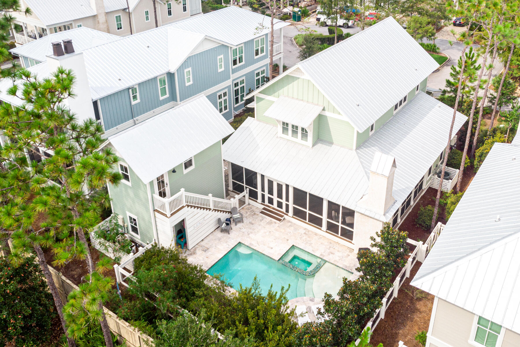 Imagine enjoying a WaterColor lifestyle from this five-bed, five-bath home with a beautiful pool and carriage house. No compromises are required in this luxury vacation home which has a proven rental history for those looking for an attractive return. Rich hardwood flooring sets the tone for a modern home with shiplap walls and many added extras. The L-shaped open living space flows through a formal dining area to the light filled open-concept kitchen with marble countertops and large island. An undercounter wine refrigerator keeps chilled drinks handy and there's an impressive wet bar with icemaker, ensuring a smooth operation. Step through French doors into the deep wraparound screened porch with lovely coquina shell fireplace and absorb the peaceful atmosphere while sipping your... .. morning coffee. Enjoy ample space for alfresco dining and relaxing overlooking the pool and bubbling spa. The impressive primary suite is conveniently located on this level while stairs lead up to a second floor living area along with 3 additional bedroom rooms all with ensuite private baths. The adjacent carriage house provides additional space for guests. Hop on your bikes and head off to explore the facilities in this 499-acre coastal resort. Named No. 1 family vacation destination in the USA, it offers unparalleled beachside amenities at the Beach Club. Stroll along the pristine white sand or take a dip in one of the pools, including one with zero entry. Tennis courts and championship golf nearby will fill your day. Meet up with friends in the evening at the sunset bar and dine well at the WaterColor Grill. This is five-star Florida living at its best.