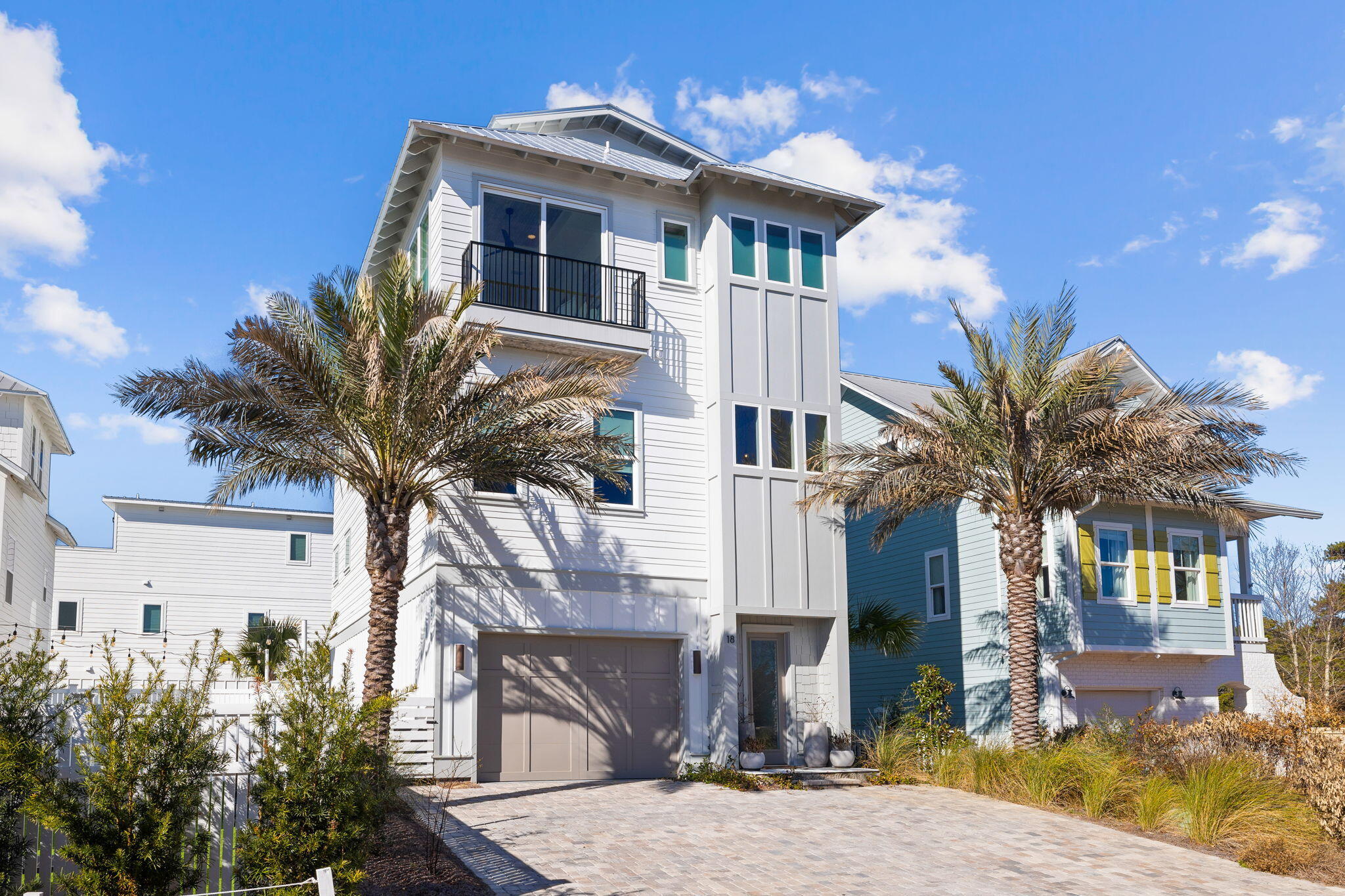 URBAN COASTAL – GULF VIEWS - FULLY FURNISHED! This impeccably designed custom Inlet Heights home, completed in December 2021, is primely located less than a mile from the iconic corridor of 30A. With 3100 square feet, this 4-bedroom 6 bath urban coastal home spans an impressive vertical footprint of 4 stories and embraces thoughtful luxury details at each level including Venetian plaster walls, peacock paver flooring, rooftop entertainment space, a putting green, and an oversized firepit. The stunning design begins with the exquisite entryway leading to the first-floor common area complete with indoor pool table, karaoke machine, full-size fridge/freezer, and wet bar. The open concept space spills outside to a private, well-design backyard/recreation area with lush landscaping and upgraded lighting, a ping pong table, cornhole, and putting green  a true outdoor oasis providing a plethora of entertainment  right down to the modern, oversized firepit for gathering on chilly fall Florida nights.
The second level impresses with 12ft ceilings, beautiful hardwood floors and stained wood ceilings. This level has the easy flow of open concept living and features the main living, dining, and kitchen space. The kitchen is well appointed with premium fixtures, semipro appliances, a five-burner gas range, light upper cabinets, and gorgeous contrasting dark lower cabinets in the kitchen island. Natural lighting, wood tones, and pristine neutral colors envelope guests in coastal urban ambience. Take in Gulf views from each of the three bedrooms comprising the third floor. The Primary Bedroom retreat is spectacular with an oversized soaking tub, marble flooring and a unique shower that boasts Gulf views as well. The fourth-floor roof access provides a delightfully surprising outdoor living space "on top of the world."  The endless gulf views and remarkable sunsets make this a favorite place to relax and unwind with the bonus of a wet bar, icemaker, drinks fridge, an abundance of space to lounge, sit and entertain. The home is EV-friendly and has a level 2 charger installed in the garage - this home literally has it all.  The location is ideal - directly across the street from four public beach access points and a short stroll to the walking trails of Camp Helen State Park. This home has access to a gorgeous community pool located on Lake Powell with a dock for launching paddle boards and kayaks.