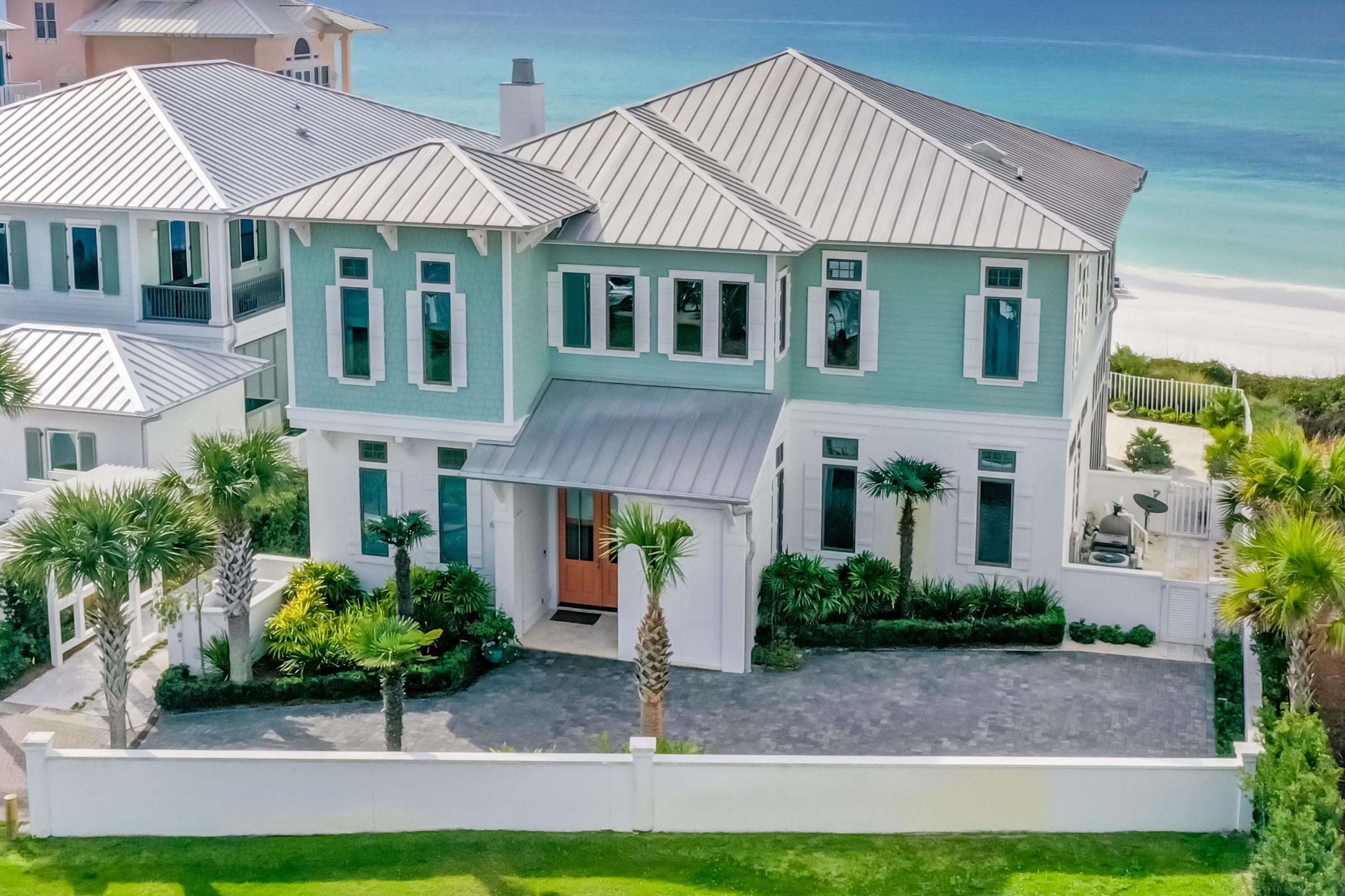 A rare opportunity to purchase an exquisitely designed home with 75 feet directly on the Gulf of Mexico in a small, gated community in South Walton County's beloved Seagrove Beach!
Upon entering the home you will notice captivating gulf views from every room of the first floor. A custom-made glass chandelier in the entry way sets the toneyou have arrived to a beautiful and unique retreat by the sea! With 14-foot pecky cypress ceilings and a stunning floor-to-ceiling Calcutta marble fireplace, the great room allows for entertaining on a grand scale. The custom-built wine cellar, which holds 1,300 bottles, and large gourmet kitchen entirely outfitted with Viking appliances will enhance your gatherings. An elevator will take you upstairs to relax and enjoy the breathtaking gulf and sunset views from each one of the two master suites. One master bathroom was designed in Carrera Marble and has an oversized marble shower and a whirlpool tub. The second master suite has a coffee bar and a Juliet balcony to savor the sea breezes. A guest bedroom with en-suite bath is currently used as an office, while two additional guest bedrooms are on the opposite end of the hallway.

Enjoy outdoor living year round with your private outdoor courtyard boasting a large saltwater pool, spa tub and fabulous summer kitchen.

An ideal find for the fabulous seaside home of your dreams!