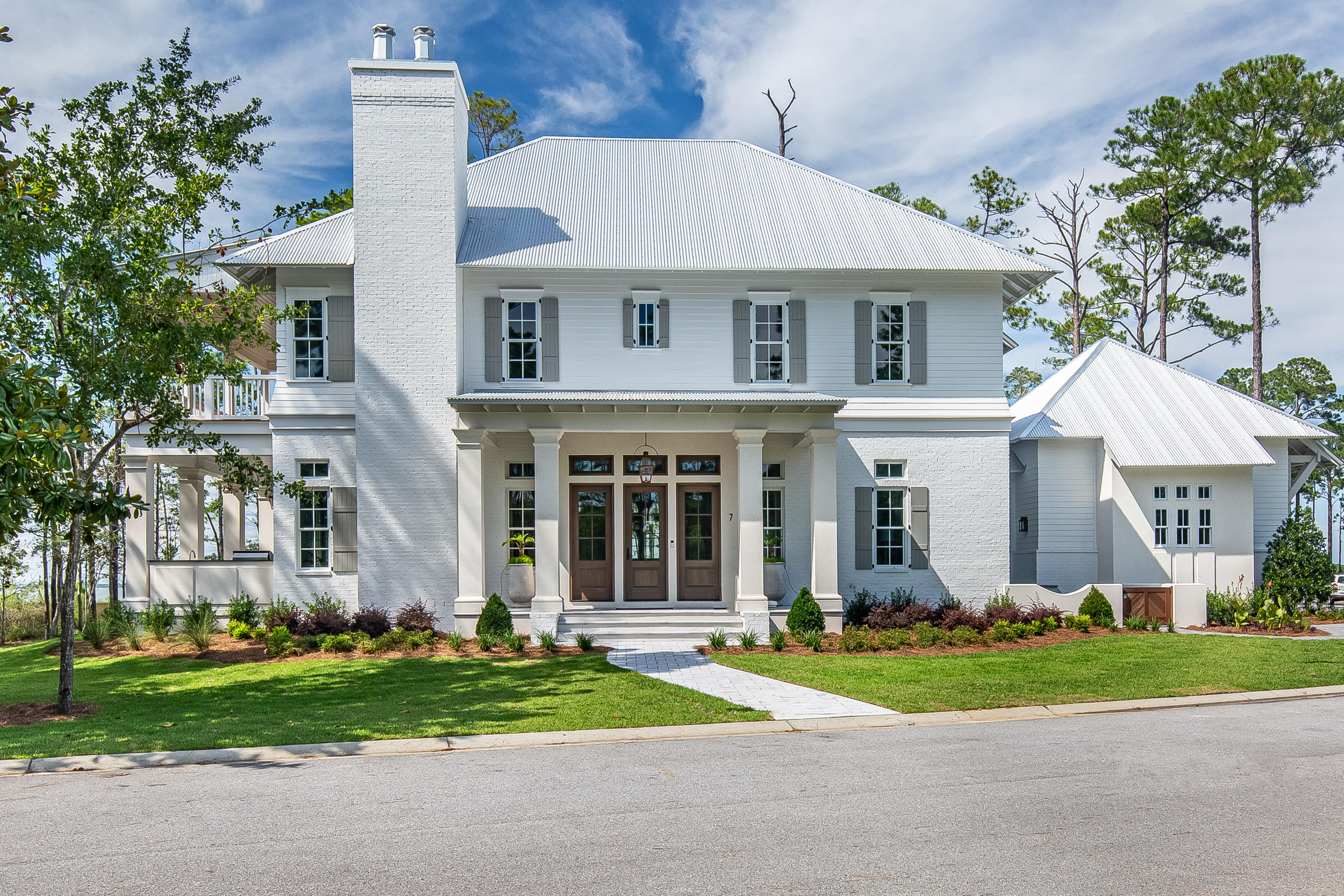 Completed in Summer 2019 in the Churchill Oaks neighborhood, this stunning home offers 4 bedrooms with one on the main level, 4 and 1 half bathrooms, a 2-car garage and extraordinary finishes such as wire-brushed oak floors, tongue-and-groove ceiling and brick accents throughout. Enjoy quiet evenings on the wide covered porch with gorgeous views of the Bay. The spacious first floor features two sitting areas with one centered around a white brick fireplace and grand dining room with a striking designer chandelier. The chef's kitchen faces the living area with beautiful quartzite counters, shaker style cabinets, a white brick accent wall, Wolf appliances including 48'' 6-burner range and Sub-Zero appliance including side-by-side refrigerator, wine cooler, and ice maker. The garage entry leads into a mudroom and butler's pantry with laundry and additional storage. Upstairs are two additional bedrooms with their own ensuite bathrooms, an office space with a sliding barn door and the master suite. The luxurious master is quite spacious with a sitting area, huge closet and expansive private porch with beautiful Bay views. A freestanding bathtub, massive shower, marble floors, quartz countertops and built-in cabinets make the master bathroom serene and functional. Tucked away with only native vegetation and the calm waters of Hogtown Bayou in sight, Churchill Oaks offers a lifestyle of elegance and appreciation of nature. Once inside the stately gated entrance, magnificent coastal homes accentuate southern architecture under a canopy of old oak trees. The 40-acre community is comprised of 87 homesites and some of the best amenities in South Walton. The Churchill Oaks Clubhouse is an outstanding 8,000 square foot amenity situated on a point on the Bay with stunning views. Three pools, exercise room, outdoor bar, fully equipped media room, commercial grade kitchen, bath and locker rooms, and large gathering spaces are all found at the Clubhouse for owners and their guests to enjoy. The latest amenity coming to the community in 2019 is a brand-new private marina. The marina project will include 36 private boat slips, paddle board storage decks, a fish cleaning station, shoreline stabilization + more!