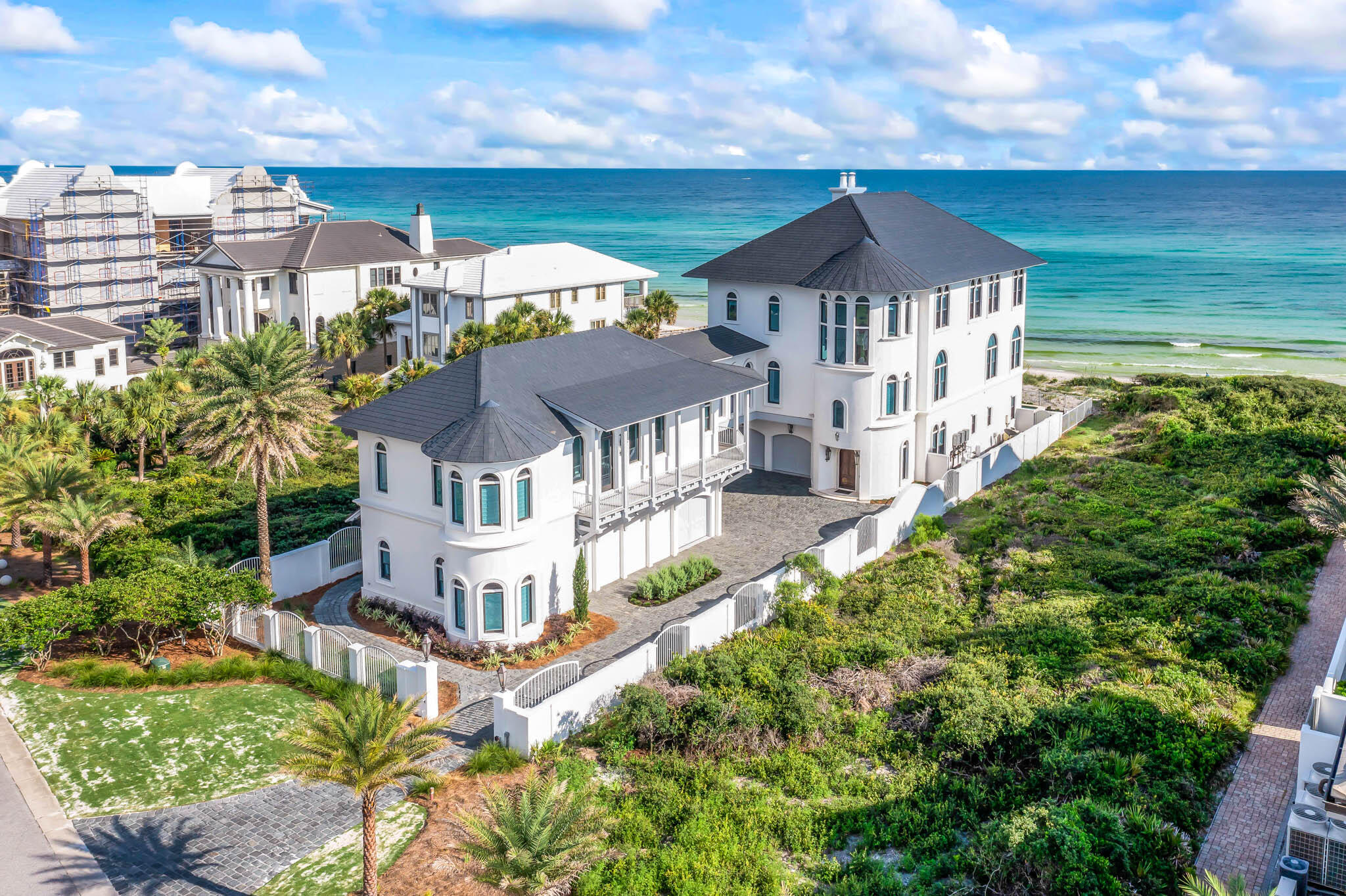 Welcome to Paradise By The Sea, the most exclusive neighborhood on 30A. 145 Paradise By The Sea is perfectly located behind the gates of this stunning community. This custom beach retreat designed by renowned architect Darrell Russell of A Boheme Design features sweeping living-dining spaces, and stunning views of the Gulf of Mexico. Natural light flows in through the floor-to-ceiling windows and illuminates the open concept living areas and high ceilings. 145 Paradise features seven bedrooms, ten bathrooms, 10,035 sq.ft heated and cooled and an additional 2,000 sq ft in porches to enjoy the breath taking views. No detail was spared in the construction of this beautiful home. Marble floors,  floor to ceiling Venetian plaster, beautiful millwork, crown molding, arched windows, columns, coffered ceilings  and full gym are some of the details in the spacious retreat. 
With lots of room to gather and relax, 145 Paradise is perfect for entertaining family and friends. The kitchen is perfect for preparing large meals, with ample storage space, high-end appliances, and a large island. Gather with friends and family on any level you chose, or head outside to the private pool and large porches- perfect place to watch the beautiful sunsets. The southern most residence features a private elevator- all three floors are easily accessible. The main residence also features five luxurious suites, while the attached carriage house contains two additional bedrooms. Don't hesitate to schedule your showing today!