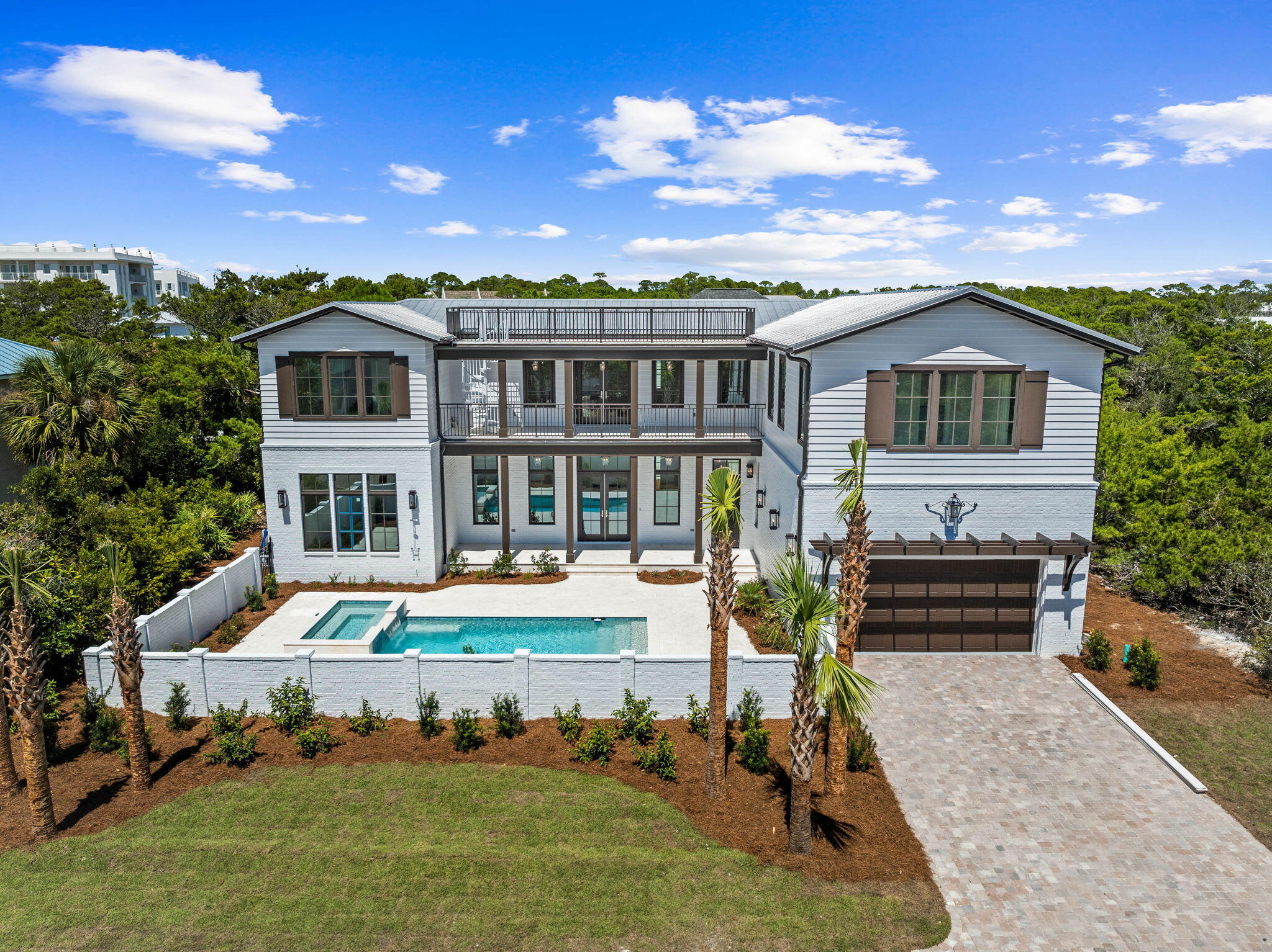 Indulge in the ultimate luxury coastal living experience with this exquisite new construction house located in the non-rental gated neighborhood of Sand Cliffs. Designed for those who appreciate fine living, this home offers deeded beach access and a stunning array of high-end features, including wire-brushed white oak hardwood floors, upscale appliances, an ice maker, wet bar, wine refrigerator, and two laundry areas. The house was designed with entertainment in mind.    The U-shaped design gracefully encloses a spacious saltwater pool, hot tub, and expansive deck, offering a private sanctuary for relaxation and gatherings.  There is a large living space upstairs that could be used as a game room along with a separate media room. From the second living area, you can sit outside on the oversized balcony or take the stairs up to the third-floor deck overlooking the Gulf and catch breathtaking sunsets.

Perfectly positioned just moments from the vibrant allure of Kaiya, Alys Beach, and Rosemary Beach, this exceptional location on the south side of 30A offers a harmonious blend of serene seclusion and effortless access to world-class dining, shopping, and entertainment.