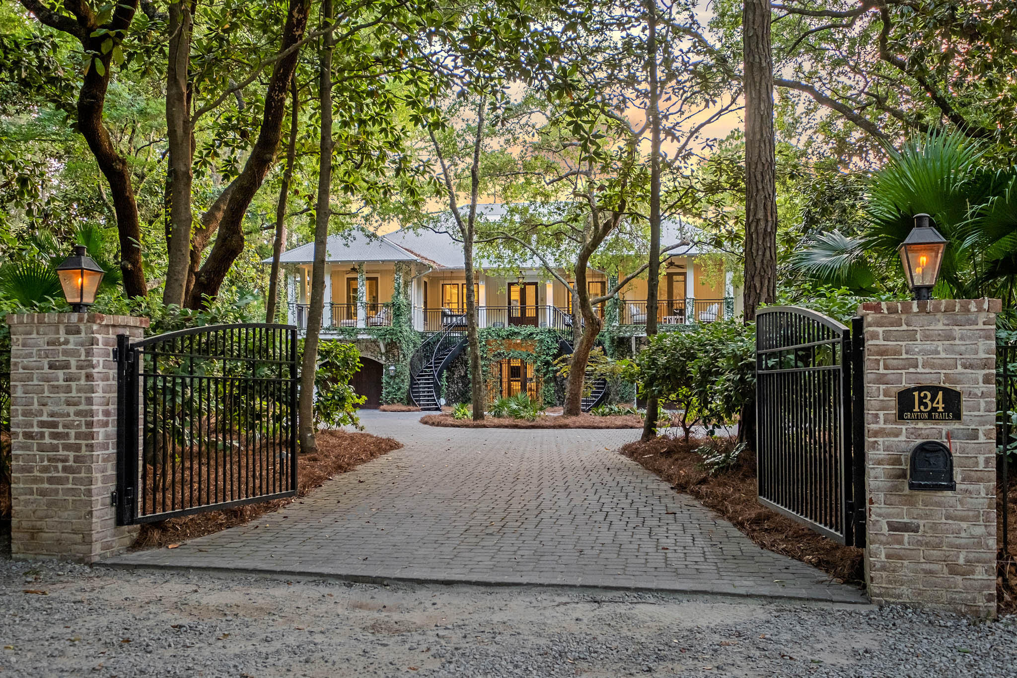 Nestled on a private road in the heart of Grayton Beach, 134 Grayton Trails is a stunning residence that exemplifies contemporary elegance and classic design. The neighborhood offers overarching mature century-old oaks, shady magnolias, and towering pines, creating a dense canopy and arguably one of the most serene settings on all of Scenic Highway 30A.

Completely renovated by the talented team at Envision Builders Group in 2021, this home encompasses over 5,600 sq ft of heated and cooled living space, including 6 bedrooms, 5.5 bathrooms, a bunk room, and a sleeping porch.

Upon entering the gates, you are greeted by a winding double staircase providing a grand entry to the main level of the home. This level combines kitchen, living and dining spaces ideally for hosting friends and family. The kitchen features high-end Subzero and Miele appliances, 600-bottle climate-controlled wine storage and custom cabinetry. This floor is complemented with 3 generous bedrooms, each with its own dedicated bathroom. The primary suite features a spacious walk-in closet with custom cabinetry, double vanity and soaking tub. Two of the bedrooms have their own private balconies. 

The lower level reveals an additional living area, two bedrooms, full bathroom, hidden bunk nook, and laundry and mud rooms. Both the first and second floors seamlessly integrate a total of six outdoor living areas, including a custom two-story screened-in pool enclosure. The large pool area is fully equipped with living and dining spaces surrounding a complete outdoor kitchen containing a full size refrigerator, gas oven, grill, island bar, sink, and custom cabinetry.

A beautifully designed two story one-bedroom, one-bathroom carriage house, complete with a full custom kitchen, living room, and dining area, is situated behind the main house and easily accessed via the short walkover off the second story main house living room or via a separate staircase on the ground level of the carriage house. The heated and cooled area below the carriage house contains a half bath and outdoor shower, and is perfectly suited for your specific needs -car collection, golf simulator, wine storage, home office, additional bedrooms or traditional garage space. 

Private, gated and situated on a generous .71-acre lot, this beautiful beach compound offers plentiful driveway and enclosed garage parking,a rare and welcomed amenity for any home on 30A, but especially for Grayton Beach. 

Lastly, there is a 7.5 foot easement along the edge of the property located directly across Grayton Trails Road providing the owner of 134 Grayton Trails with full access to Western Lake. This easement allows the owner to explore the rare coastal dune lake. A truly unique feature, this is the only lot on Grayton Trails Road offering both the privacy of an estate sized interior lot and deeded lake access.