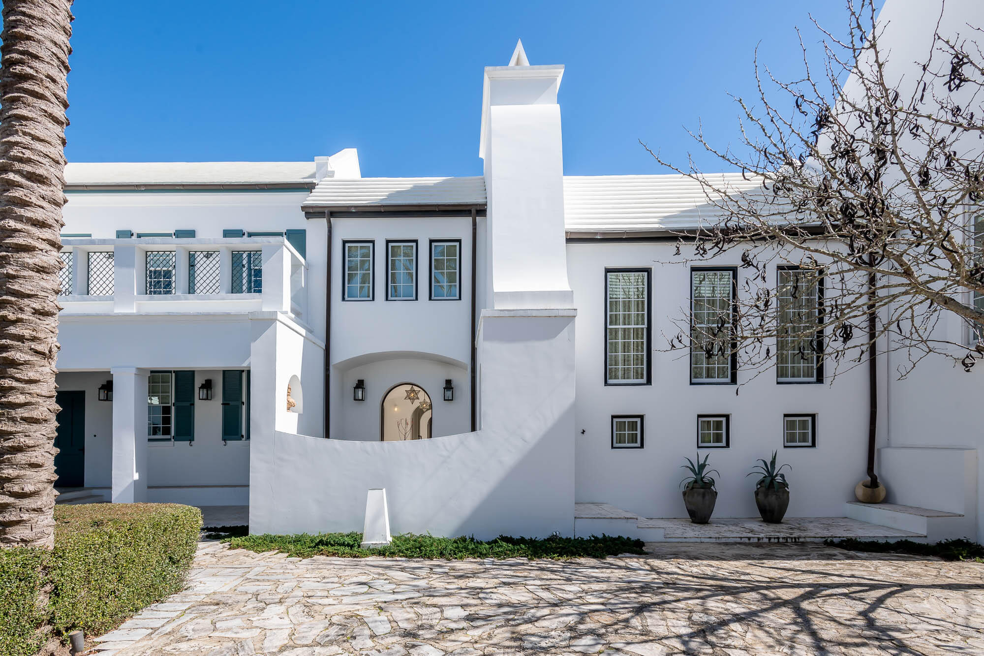This highly anticipated home was designed by the world-renowned design firm of Miami based Duany Plater-Zyberk & Company, architect & creator for the town design of Alys Beach. The home's design captures all aspects of Antiguan & Guatemalan influences showcasing dual Courtyards, Loggias, Roof Terrace, and dualling Zaguans.
The property opens to Sea Garden Walk pedestrian path which leads directly to the Gulf of Mexico and the private owners Beach Club. A 2nd attribute to the pedestrian path is the intimate pocket park with fire pit for afternoon sittings wonderfully landscaped.  The Caliza Pool & Town Center is a short stroll as well.  The 1st level entry through a mahogany gate leads you into the Zaguan and 1st of 2 private courtyards with seating and outdoor grill.  This Courtyard separates the Kitchen & Living Room that features banks of French doors to open bringing all spaces into one for exquisite entertaining.  The Living Room boasts 18-foot ceilings that captures dramatic natural light by way of east to west sunlight.  Opening the bank of French Doors to the courtyard allows for the spaces to become one.  Exquisite furnishings and art compliment the scale of the dual height ceiling.  The Kitchen & Dining Room create separation between the Primary Suite and Living Room centered in the home.  French doors align this area which provide access to each of the 2 Courtyards.  The Kitchen's natural marble stone signifies the rooms ambiance. The 2nd Zaguan and courtyard shares intimate space with the pool integrated between the Kitchen and Primary Suite. The secluded and romantic first floor Primary Suite hosts a serene fireplace looking over the Courtyard pool. This suite is designed with closets for two along with beautiful stonework in the dual vanity bathroom.  The 2nd level satisfies guest accommodations having two private bedrooms with en suite bathrooms.  Each of the two bedrooms each have their own separate room with sitting areas.  The gorgeous Roof Terrace is the divide between both guest suites for evenings under the stars.  Day Beds swing and chaise lounges provide the relaxation. Many design features unique to Alys Beach are showcased such as seamless blending of indoor and outdoor spaces, privacy, exquisite finishes, and superior sustainable construction. The home is offered inclusive of the professionally décor and furnishings.  This home personifies the Alys Beach lifestyle.