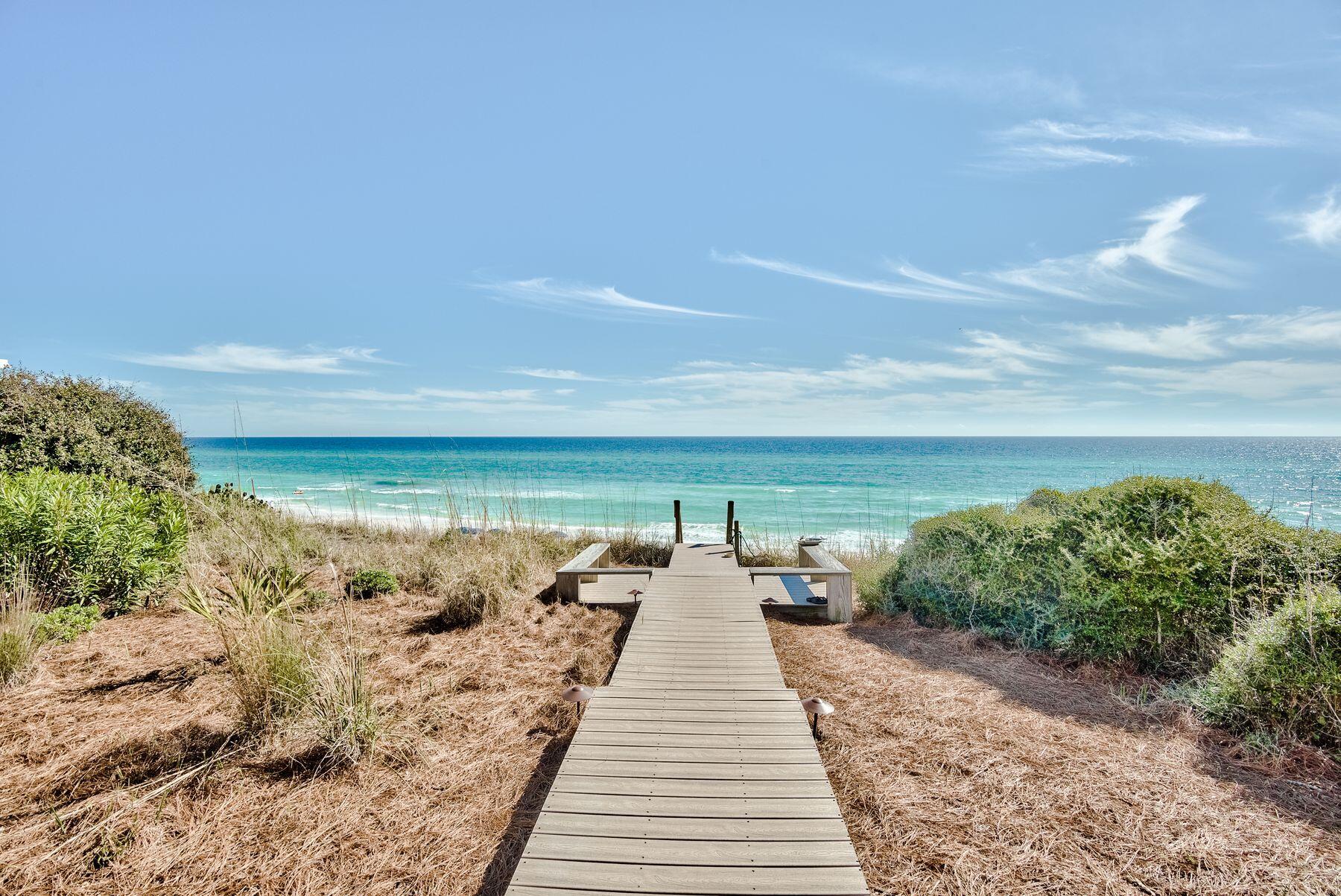 Life doesn't get much better than living on the Gulf of Mexico, and beach homes don't get much better than this estate bordering the pearl white sands and overlooking the emerald green waters. The private boardwalk begins at the back deck and ends where your toes meet the sand. This property encompasses nearly three-quarters of an acre and beckons all who appreciate superior workmanship, striking style and distinctive quality in a majestic beachfront setting. Beyond its incredible location, this elegant three-story, 6,453 sqft, five-bedroom, six-and-two-half bath home offers an abundance of exterior living space with beautifully renovated interiors. The first level offers two spacious attached garages, one being climate controlled, ample storage both interior and exterior, a full bathroom and an elevator that reaches all three levels. In addition, the spacious flex room offers areas for the entire family to enjoy with a large wine fridge and tasting area, fitness area, television and a custom Murphy bed for additional guest sleeping. The main level features floor to ceiling views of the Gulf of Mexico framing the dining, living and gourmet kitchen all seamlessly flowing together with an abundance of natural light. The enchanting kitchen space provides a luxurious focal point for gathering with friends and family while enjoying direct Gulf views, while the adjacent dining area ensures convenience for everyone who spends time within this beautifully updated coastal retreat. The main living area offers ample room for relaxation or togethering, while a centerpiece fireplace and plentiful windows provide a dramatic background at any time of the day. A Gulf front guest suite offers a private space for guest stays with an attached full bathroom, balcony access and gorgeous views. The third floor offers three additional guest suites each with an attached bathroom, an office with beautiful woodwork and a sprawling master suite. The master suite leaves nothing to be desired with forever Gulf vistas from the oversized windows, vaulted and beamed ceilings, a bathroom with dual vanities, jetted tub and walk-in shower. The attached sitting room with a wet bar and half bathroom offers the perfect setting for peaceful sunrise and sunset viewing. The Village of White Cliffs is a non-rental, gated, community located in Blue Mountain Beach, directly off Highway 30A. The community walkover offers convenient bathrooms and a lookout tower overlooking a sprawling private beach. Located in the heart of White Cliffs is the amenity center with a seasonally heated community pool, lighted tennis court and clubhouse with a full kitchen, a billiards room, gathering space and fitness room.