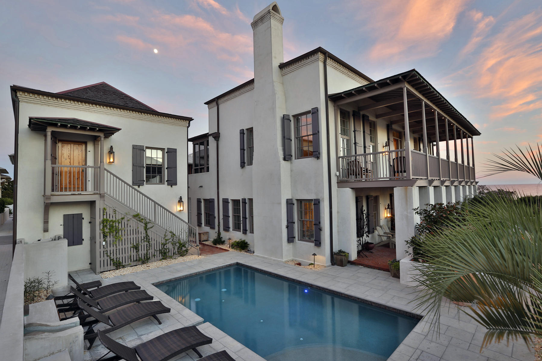 The history of this Rosemary Beach residence begins well before its 2001 completion with a collaboration between noted Interior Designer Phillip Sides and Architect Lew Oliver to create the sixth Southern Accents magazine Decorator Show Home. Presiding over 85 feet of majestically elevated beach front along the emerald Gulf of Mexico waters unique to Northwest Florida, this concrete block construct leaves little to be desired. Located alongside a beach bound boardwalk, the walled property contains a five bedroom main house, one bedroom carriage house over a two car garage, as well as a stone paved courtyard with full size pool, fountain, and lush landscaping. A 2008 redesign evolved the already extraordinary waterfront home to its current state of grandeur. Among its notables is a gulf front great room on the second floor with lofty exposed beam ceiling and designer kitchen whose luxurious feature wall of woven marble and bronze, and furniture grade cabinets, quietly obscure its many pragmatic attributes. The master suite is joined by three unique and privately situated guest retreats on the first floor, and on the second floor, an additional guest bedroom may also serve as a library or media room depending on the needs of its new owner. Finally, deep covered verandas line the south and west facing facades, capturing both gulf views and sensational sunsets over the water come fall and winter. Rosemary Beach is one among an exclusive company of preeminent new urbanism beach towns, found along Scenic Highway 30A. The planning concept emphasizes accessibility, placing local restaurants, shops and other attractions in a central location not far from surrounding homes. From this home, Northwest Florida Beaches International Airport is a 30 minute car ride away.