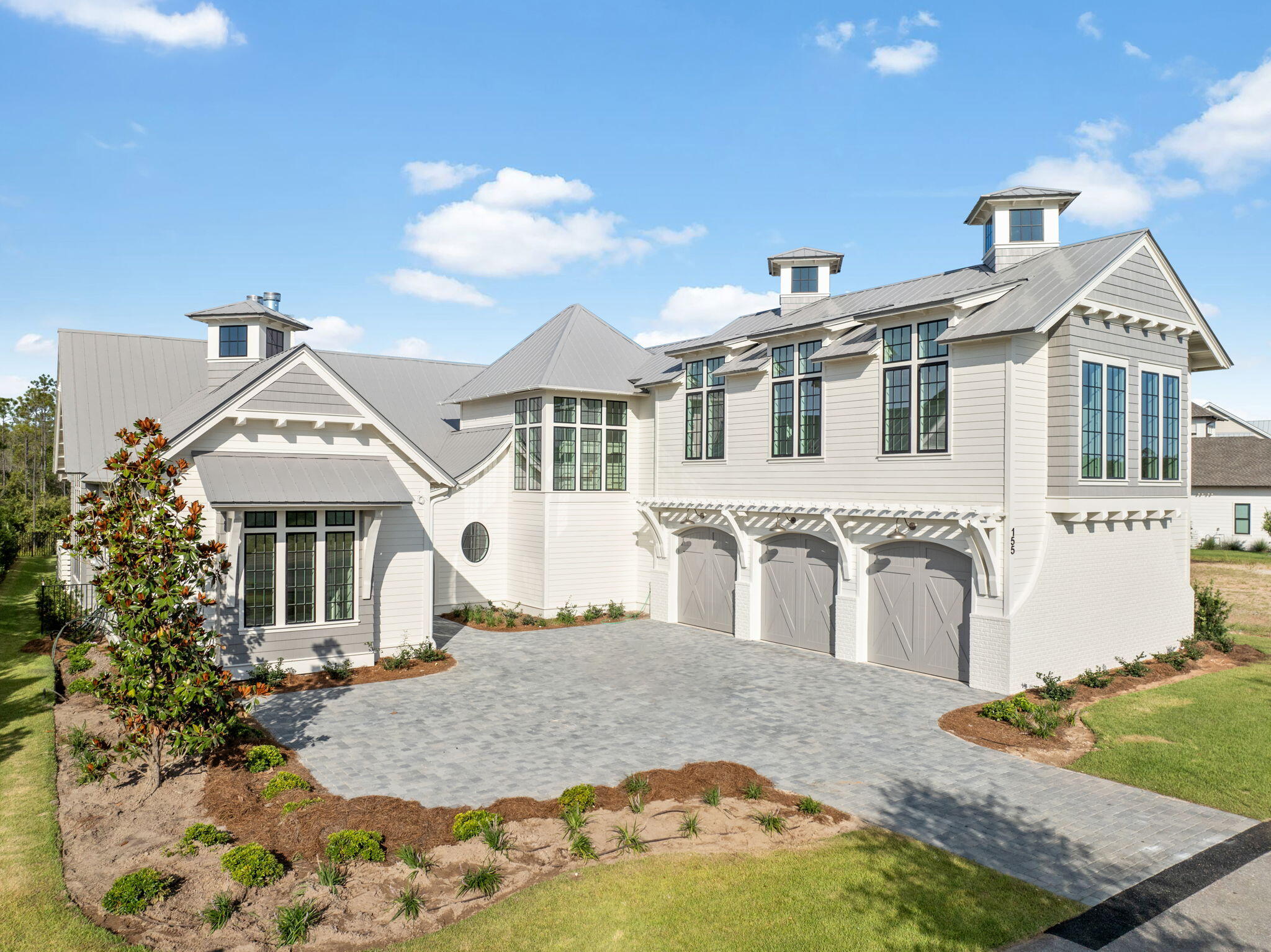 Newly constructed and thoughtfully designed, 155 Golfridge Drive offers over 6,200 square feet living space within the private, gated community of Watersound Camp Creek. Outside Centered around a private interior courtyard with a pool, spa, and covered outdoor living area, this home combines high-end design with functional layout.

The first level features a spacious primary suite with sitting area, large walk-in closet, and spa-style bath, along with two additional guest suites, a gourmet kitchen with Wolf appliances, walk-in pantry, and open-concept living and dining areas. Just off the main living space, a private sitting room includes a built-in wet bar, vaulted ceilings, and custom finishes that add to the home's distinctive character. Upstairs, two guest suites and a bonus room with wet bar offer flexible living space. A cupola adds architectural interest and natural light throughout. The attached 3 car garage and driveway provide ample parking, and the home backs to preserved green space for added privacy.

Located within Watersound Camp Creek, residents enjoy access to club amenities including golf, dining, fitness, and pools. 

Buyer to verify all dimensions and information.