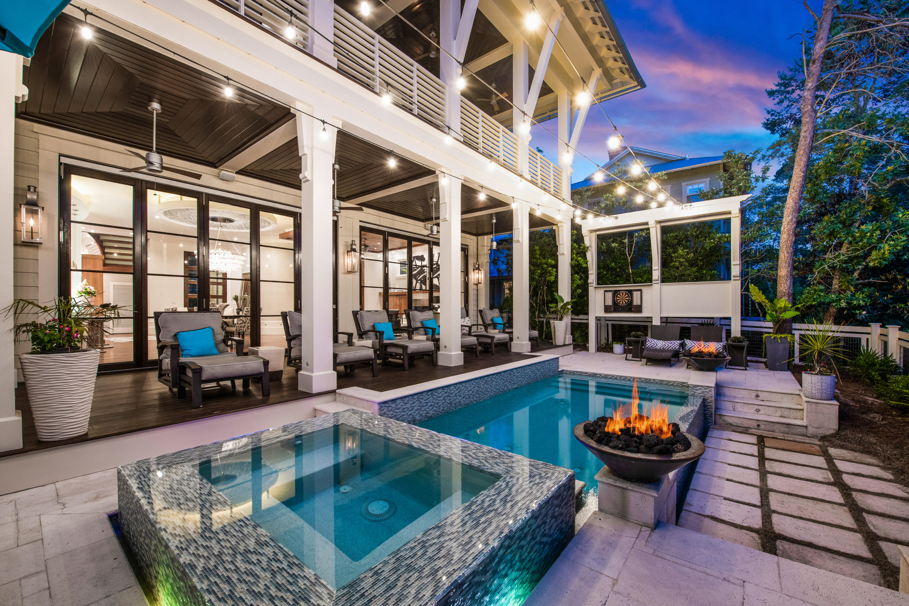 A truly one-of-kind opportunity, this impressive 5 Bed/5 Bath/3 Half Bath WaterColor estate nestled along the peaceful shores of Western Lake offers a luxurious lifestyle not easily attained in the 30A area with every desirable feature imaginable including a lake front infinity edge swimming pool with outdoor living area, a high-tech theater room with wet bar, an elevator, recently updated furniture & finishes, and a two-car garage. Designed by Savoie Architects, the elegant, contemporary styling of this residence sets it apart from other community properties. A welcoming covered front porch is highlighted by a stunning 11' mahogany front door with custom beveled glass. The gracious foyer leads to an open concept living and dining area with gorgeous Brazilian walnut floors and walnut wine display and ceiling accents including
a built-in entertainment center. A travertine marble hearth complements the linear Napoleon gas fireplace creating a cozy atmosphere for gathering with a wall of natural light from the Merbeu wood folding door system across the rear of the home overlooking the picturesque lake front pool area.


Designed by German manufacturer Poggenpohl, the kitchen stuns with floor-to-ceiling cabinetry, open glass shelving, quartz countertops, a white ice tile ceiling treatment, a quartz waterfall center island with Miele glass top stove and vented hood, a custom Miele appliance package, Bosch twin dishwashers, and built-in Sub-Zero refrigerator and freezer. A contemporary glass breakfast bar seats five while an additional light-filled dining space is located off the kitchen with a contemporary glass chandelier. Custom-designed tables and chairs imported from Italy complete the dining spaces.
Open the folding door system in the living and dining area to unite the indoor and outdoor entertaining spaces gather around the waterfront patio with heated infinity pool, spa, summer kitchen, two fire bowls, outdoor tv, and ample lounge space all overlooking the tranquil coastal landscape surrounding Western Lake. Two offices, and two powder rooms are also located on the first floor.
A striking stairwell with stainless handrails and frosted glass back-lit risers dazzles with a custom 30-foot glass chandelier that effortlessly hovers above all levels. On the second level, find two covered porches, a powder room, a guest room with balcony, and the theater room. Professionally designed, the theater room features state-of-the-art lighting and projection system, a 140" sound-thru screen, two rows of recliners, and a wet bar. The master suite is also located on this level featuring wood and tile accent walls, a linear gas fireplace, tray ceiling, private balcony, and his and hers walk-in closets. The stunning ensuite offers a soaking tub, glass shower with rainfall shower head, an oversized vanity, and walnut accents.


The third level includes two guest suites and a bunk room, each with a private bathroom. Additional features of this property include a large driveway, two-car garage, state-of-the-art Control 4 system that powers home audio and video throughout the home with a touch system also compatible with Apple devices, a central vacuum system, and a Guardian Air 'Clean Air System'. 

Located on 499 acres in the renowned South Walton beaches, the WaterColor community offers the charm of small-town life. Exceptional community amenities include six beautiful swimming pools, a recently renovated gulf front beach club, nature trails, a Boathouse offering kayaking, canoeing and paddle boarding, a fitness center, outstanding tennis facility, Camp WaterColor for kids with lazy river and waterslide, parks, and green spaces.