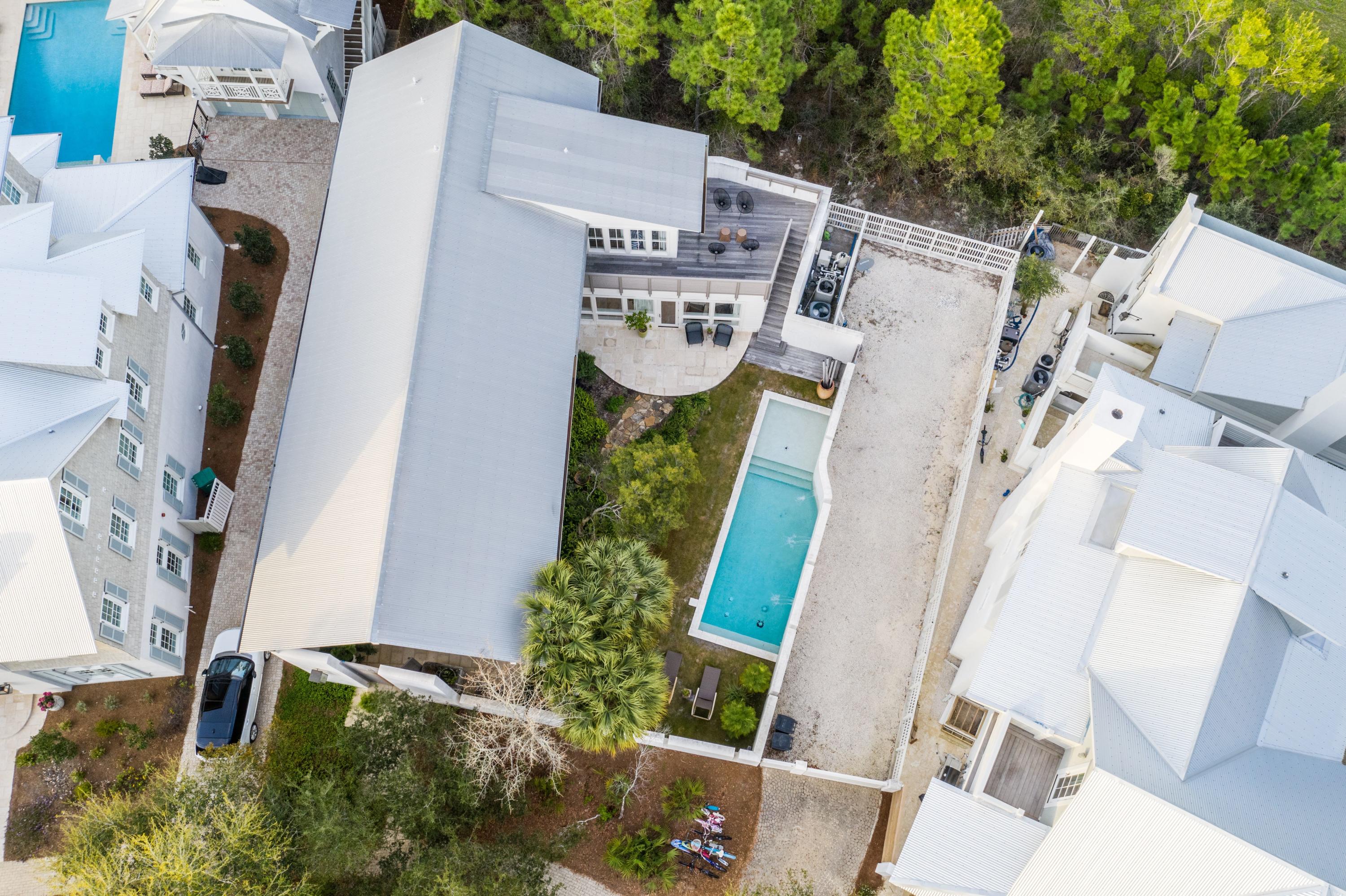 This 4 bedroom 4 bath contemporary beach home designed by Carey McWhorter sits on one of the largest lots in Rosemary Beach and offers a spacious courtyard, pool, patio and covered loggia. Amazing outdoor living space! Ample room to build a carriage house on this home site (current owners have HOA approval on this). The first floor of this home offers an open living area and a soaring  28 foot vaulted and beamed ceiling making for an amazing airy space to have family gatherings or entertain guests. The kitchen has all the finest appliances, stainless steel Dacor gas stove and oven, Dacor microwave, Viking wine cooler, Viking refrigerator, marble counter-tops a modern custom walnut cabinetry.  The home offers a very practical utility room with is completed with a Miele washer and dryer a second refrigerator and pantry area.This property offers a first floor master bedroom with a master bath en-suite which showcases dual vanities, tile, an over sized shower and his and hers custom built walk in closets. One additional guest bedroom and full bath is on the first floor. The second floor offers two additional guest bedrooms and two full baths. The second floor balcony overlooks your private courtyard and pool. This home offers ample closets and storage space. This home is located just 4 houses west of one of the 4 pools in Rosemary Beach. The town also offers a half mile of beach frontage, cabana service, nine dune walkovers, boardwalks, bike paths, eight clay tennis courts, racquetball club, health club, Town Hall and a lively Town Center with a variety of shops and restaurants. Call to schedule a showing of this Rosemary Beach retreat today!