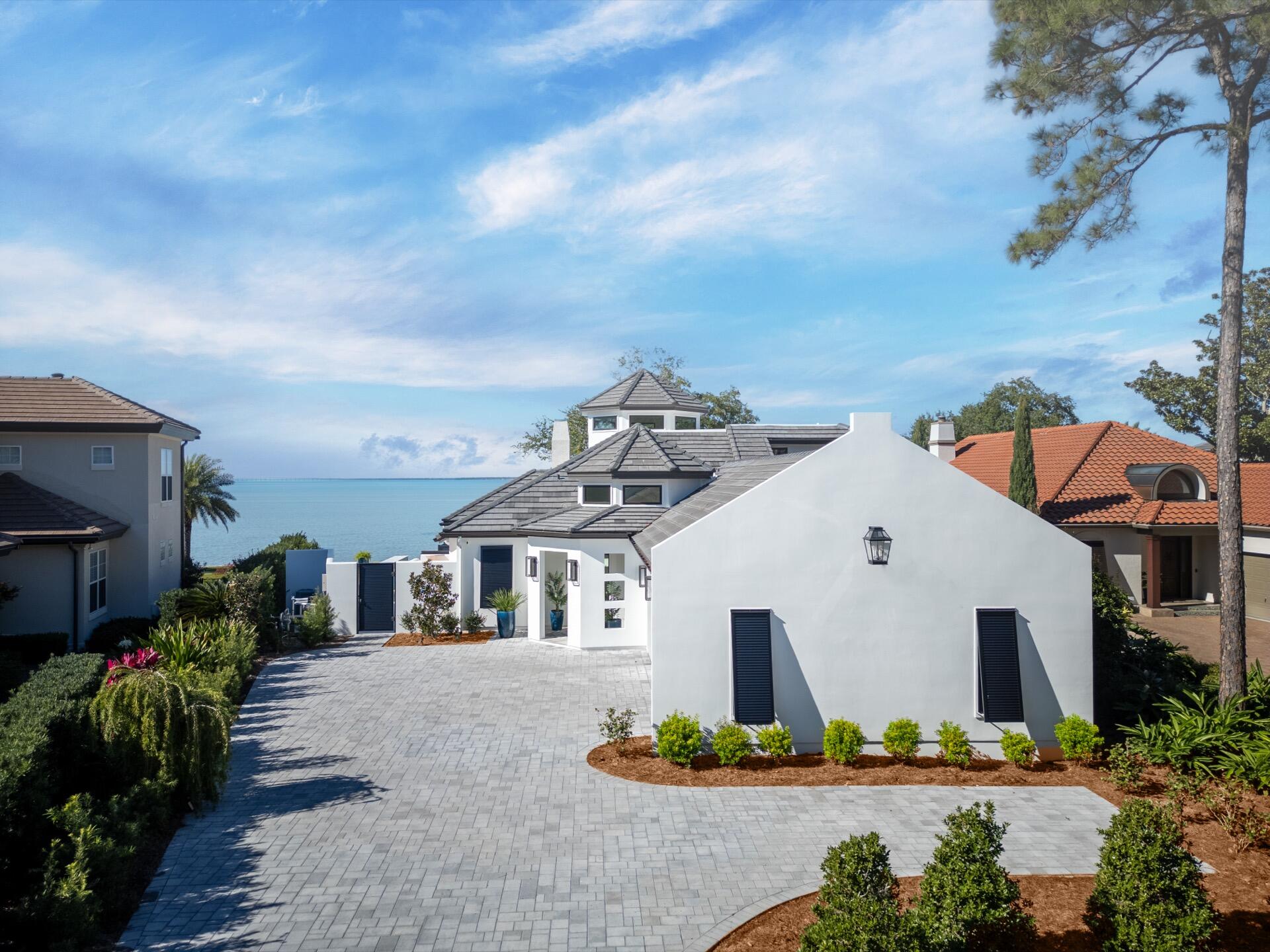 BAYFRONT MASTERPIECE BEHIND THE GATES OF BURNT PINE AT SANDESTIN. HOME HAS UNDERGONE A NEARLY 3 YEAR RENOVATION AND HAS BEEN COMPLETELY REBUILT DOWN TO THE FOUNDATION AND STUDS AND IS LIKE A NEW HOME. NEW TILE ROOF, HURRICANE RESISTANT WINDOWS, STUCCO WALLS, INTERIOR DRYWALL, FLOORING, NEW PLUMBING, LED LIGHTING & LIGHT FIXTURES, DUCTS, FURNACES, AND HVAC'S, POOL, SEAWALL AND DOCK. SMART HOME is 4333 SQ. FT. 4 BEDROOM AND 4 FULL BATHS AND 2 HALF BATHS. KITCHEN HAS TOP OF THE LINE APPLIANCES, PANTRY, COFFEE BAR. MEDIA ROOM WITH 120' PROJECTION TV, 12 FT. SLIDING GLASS DOORS OPEN TO THE BAY AND OUTDOOR KITCHEN AND FIREPIT. FIRST FLOOR PRIVATE MAIN SUITE HAS HIS & HER CLOSETS AND BATHROOM HAS A WET ROOM FOR THE SHOWER & TUB. ALL BEDROOMS HAVE THEIR OWN FULL BATH.  HOME HAS IT ALL!!!